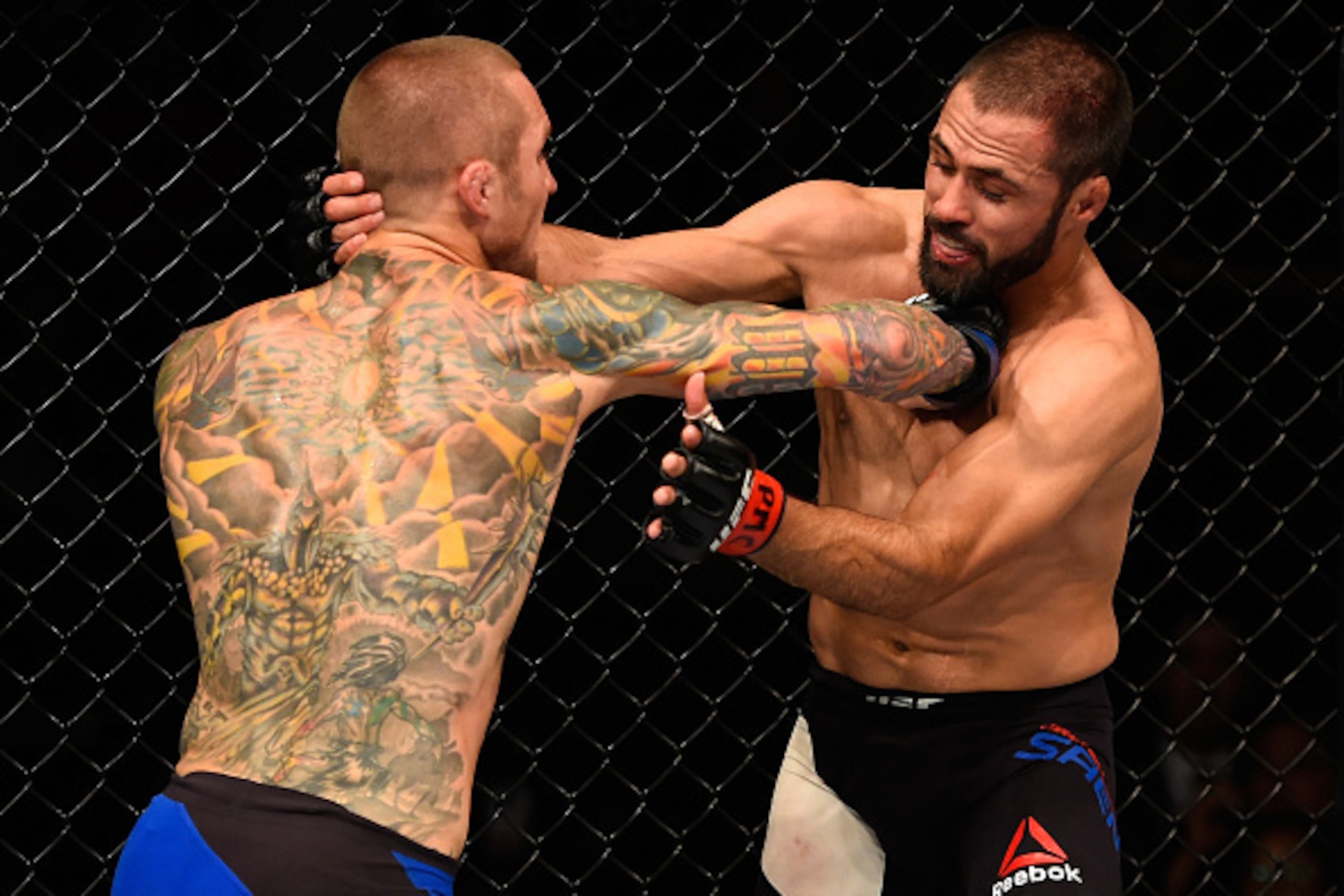 CHICAGO, IL - JULY 23:  (L-R) Eddie Wineland punches Frankie Saenz in their bantamweight bout during the UFC Fight Night event at the United Center on July 23, 2016 in Chicago, Illinois. (Photo by Josh Hedges/Zuffa LLC/Zuffa LLC via Getty Images)