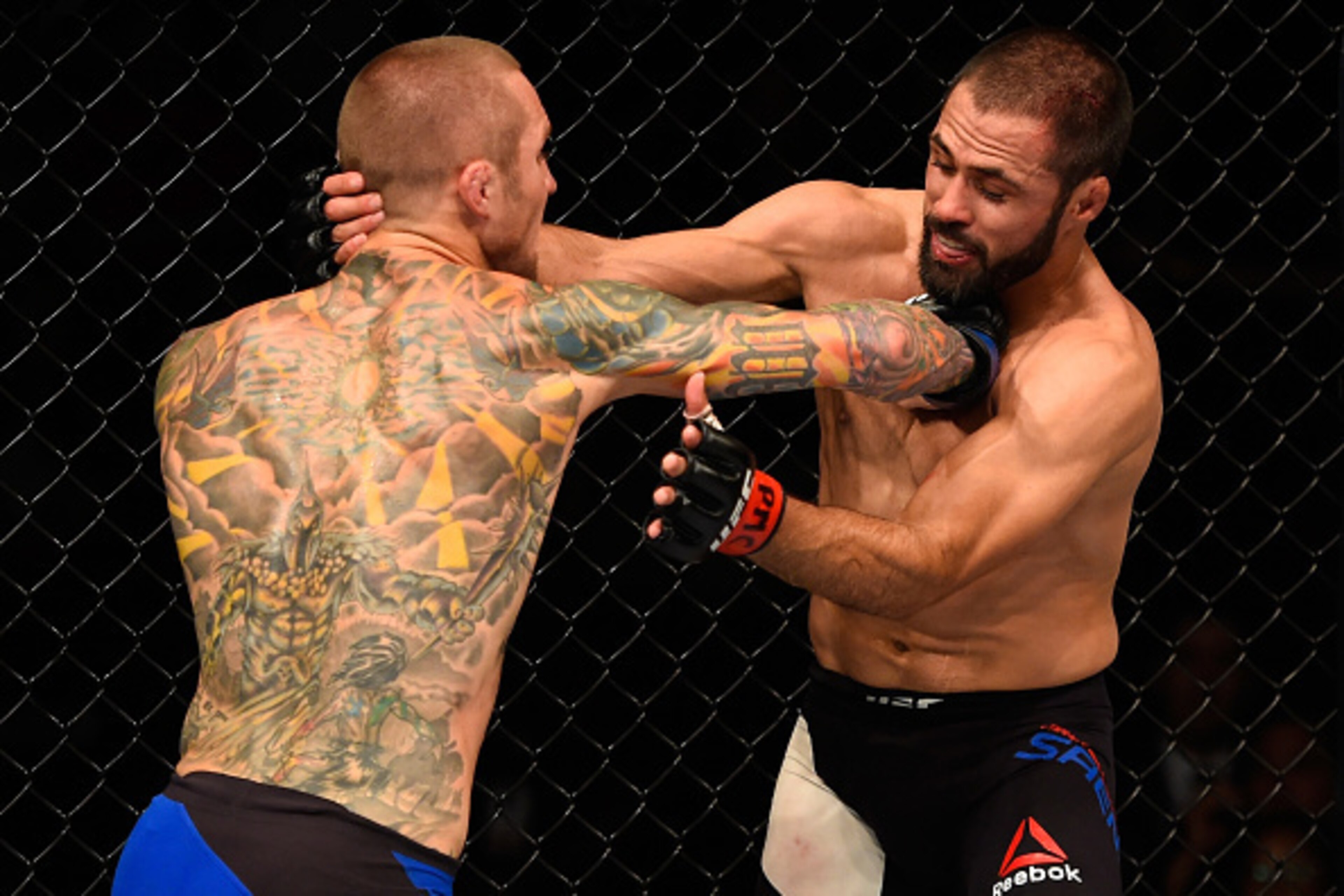 CHICAGO, IL - JULY 23:  (L-R) Eddie Wineland punches Frankie Saenz in their bantamweight bout during the UFC Fight Night event at the United Center on July 23, 2016 in Chicago, Illinois. (Photo by Josh Hedges/Zuffa LLC/Zuffa LLC via Getty Images)