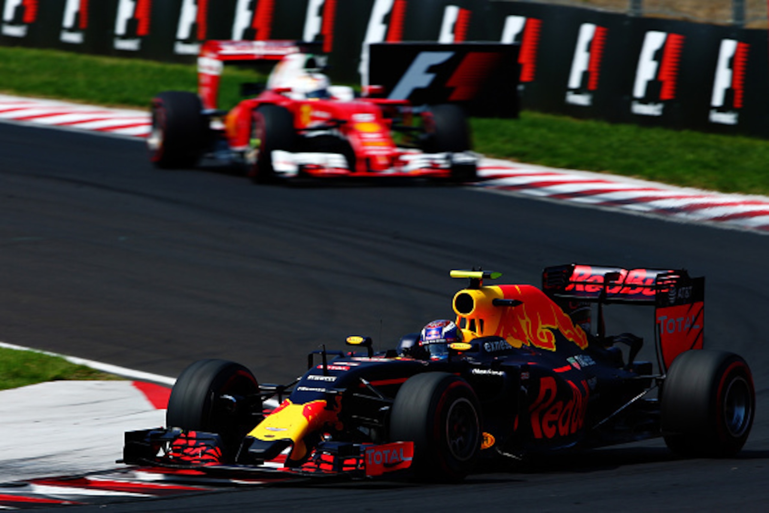 BUDAPEST, HUNGARY - JULY 24:Max Verstappen of the Netherlands driving the (33) Red Bull Racing Red Bull-TAG Heuer RB12 TAG Heuer leads Sebastian Vettel of Germany driving the (5) Scuderia Ferrari SF16-H Ferrari 059/5 turbo (Shell GP) on track  during the 
