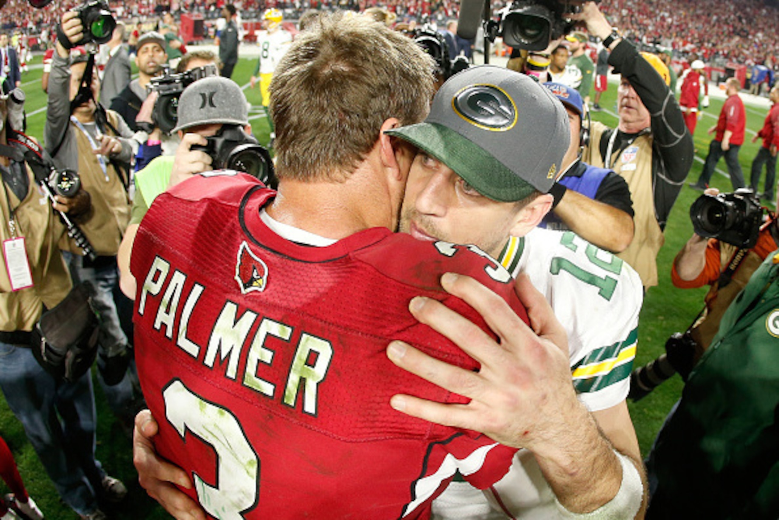 GLENDALE, AZ - JANUARY 16:  Quarterback Carson Palmer #3 of the Arizona Cardinals shakes hands with quarterback Aaron Rodgers #12 of the Green Bay Packers after the Arizona Cardinals beat the Green Bay Packers 26-20 in overtime of the NFC Divisional Playo