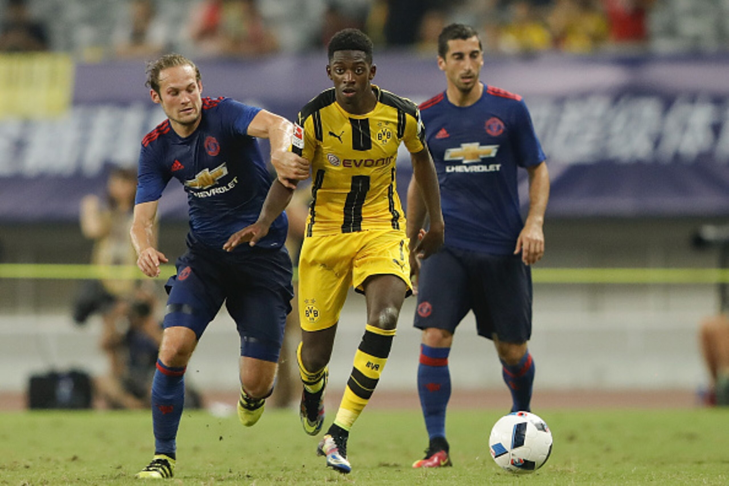 SHANGHAI, CHINA - JULY 22:  Daley Blind of Manchester United competes for the ball with Ousmane Dembele of Borussia Dortmund during the International Champions Cup match between Manchester United and Borussia Dortmund at Shanghai Stadium on July 22, 2016 