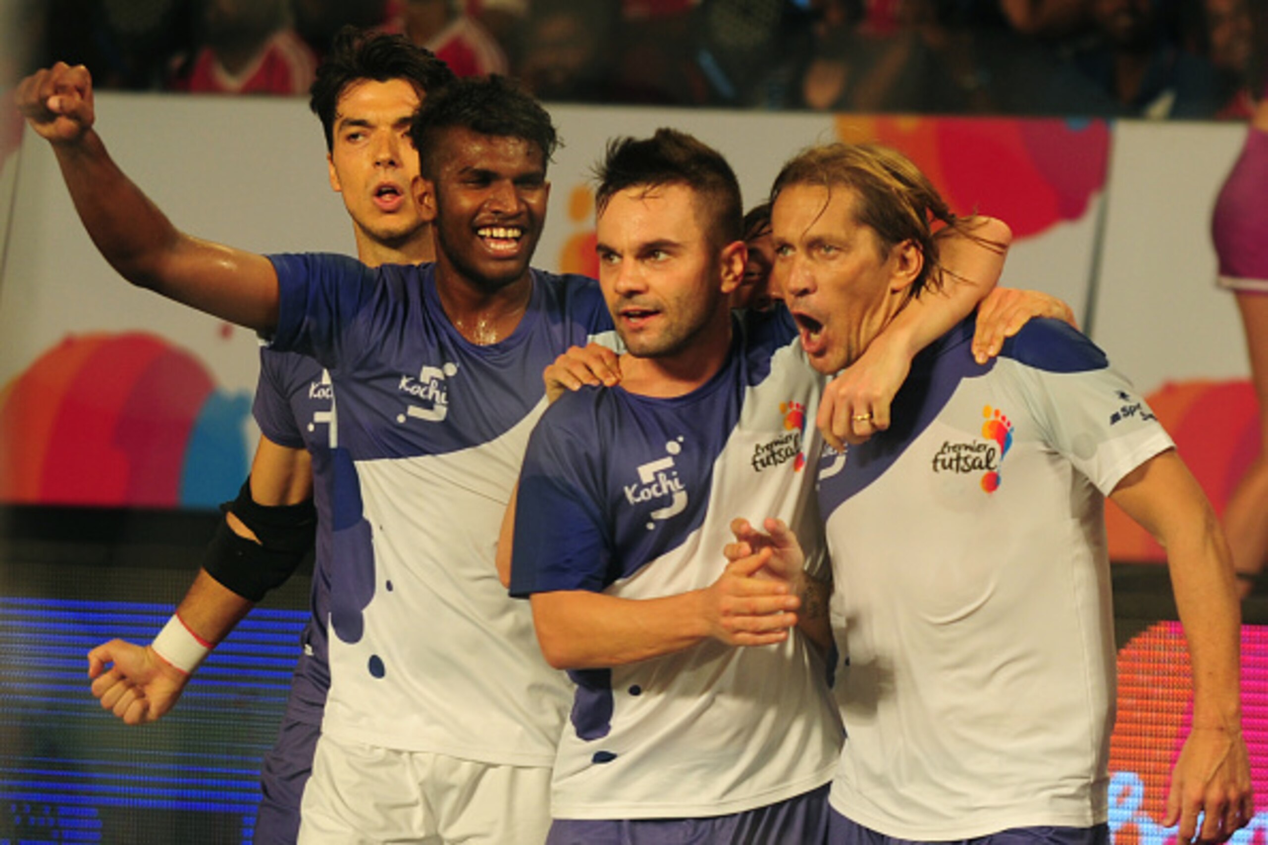 Kochi's Miguel Salgado (R) celebrates after scoring a goal against the Mumbai 5's during their Premier Futsal Football League match in Chennai on July 16, 2016. / AFP / ARUN SANKAR        (Photo credit should read ARUN SANKAR/AFP/Getty Images)