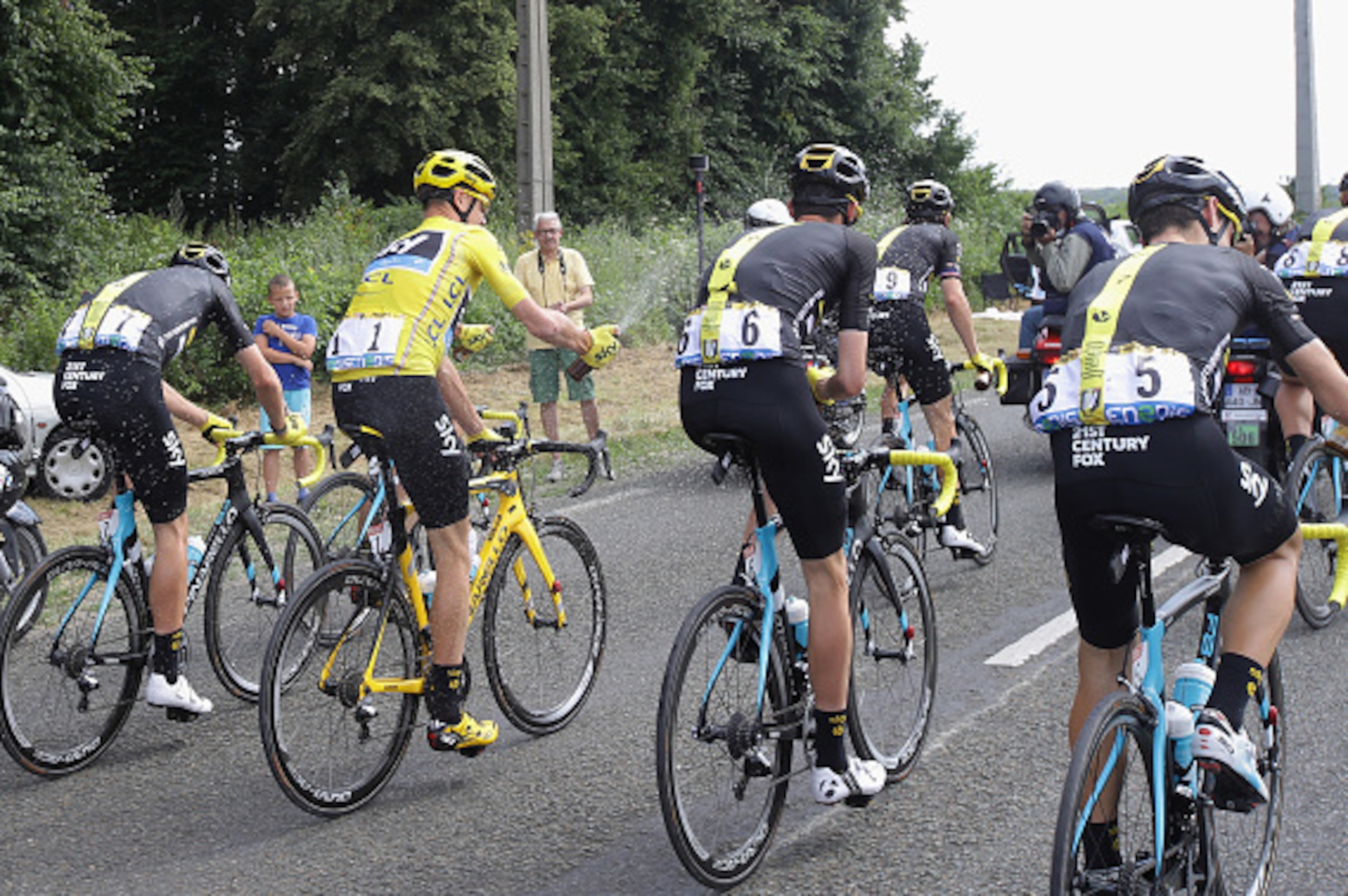 PARIS, FRANCE - JULY 24:  Chris Froome of Great Britain and Team Sky sprays a bottle of beer over his team mates during stage twenty one of the 2016 Le Tour de France, from Chantilly to Paris Champs-Elysees on July 24, 2016 in Paris, France.  (Photo by Ch