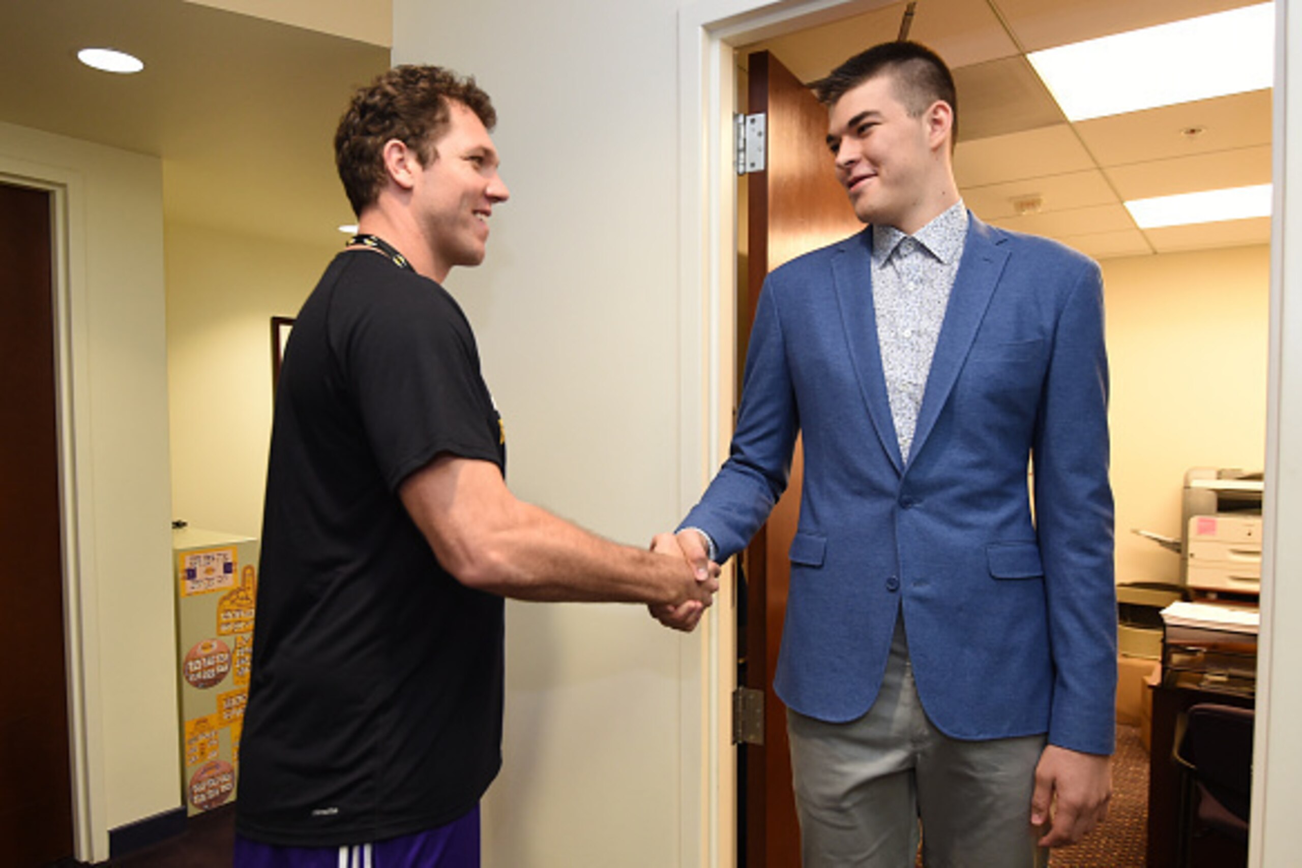 EL SEGUNDO, CA - JULY 5: Ivica Zubac #40 of the Los Angeles Lakers and Head Coach Luke Walton shake hands before a press conference to introduce Los Angeles Lakers draft picks Brandon Ingram and Ivica Zubac on July 5, 2016 at Toyota Sports Center in El Se