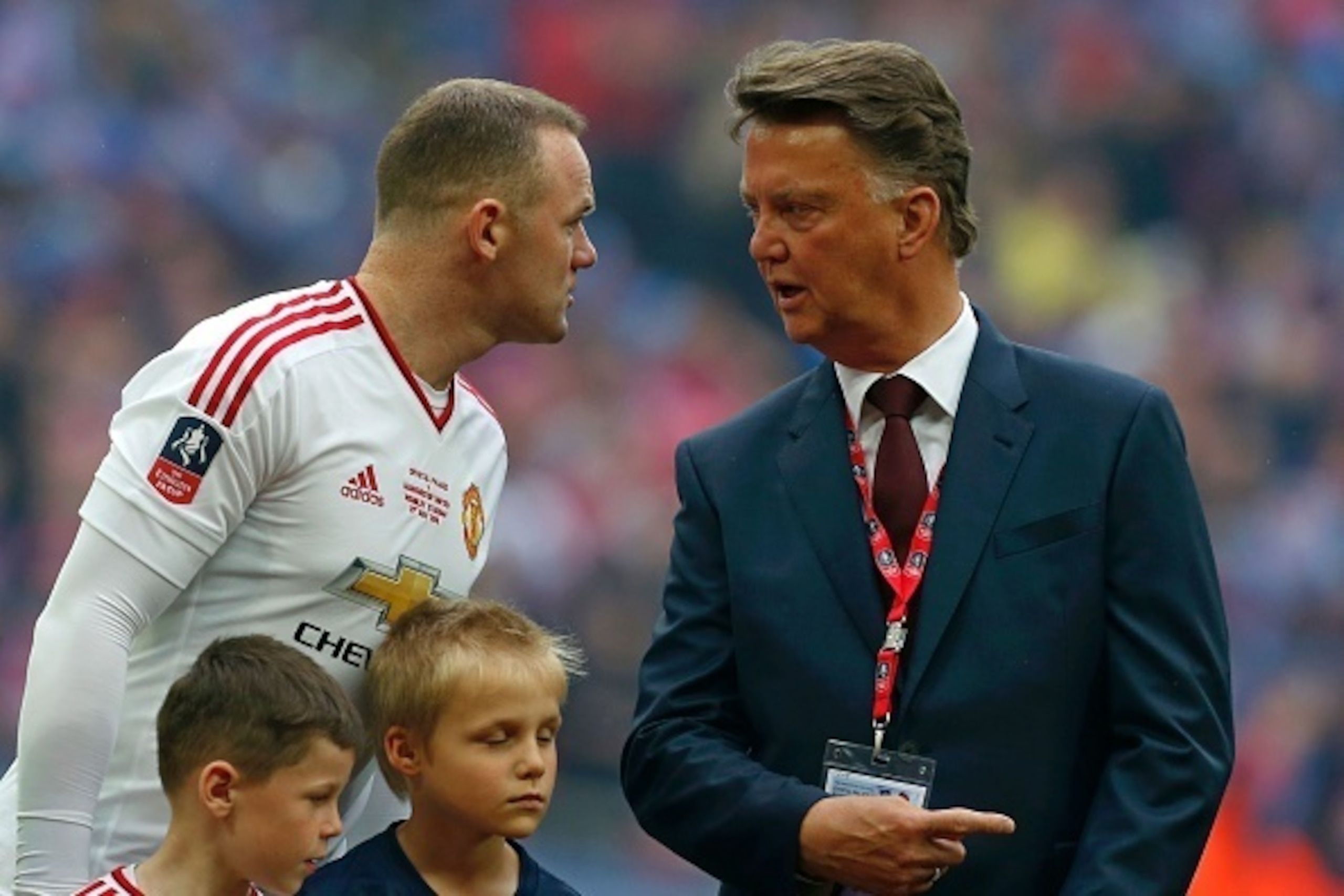 Manchester United's Dutch manager Louis van Gaal (R) speaks with Manchester United's English striker Wayne Rooney before the start of the FA Cup trophy following the English FA Cup final football match between Crystal Palace and Manchester United at Wembl Manchester United's Dutch manager Louis van Gaal (R) speaks with Manchester United's English striker Wayne Rooney before the start of the FA Cup trophy following the English FA Cup final football match between Crystal Palace and Manchester United at Wembl