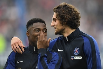 Paris Saint-Germain's French midfielder Adrien Rabiot (R) talks with Paris Saint-Germain's Ivorian defender Serge Aurier (L) prior to the French Cup final football match beween Marseille (OM) and Paris Saint-Germain (PSG) on May 21, 2016 at the Stade de F