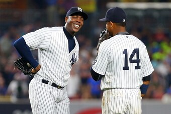 NEW YORK, NY - JULY 22: Aroldis Chapman #54 of the New York Yankees shares a laugh with Starlin Castro #14 during the ninth inning against the San Francisco Giants at Yankee Stadium on July 22, 2016 in the Bronx borough of New York City.  (Photo by Mike S