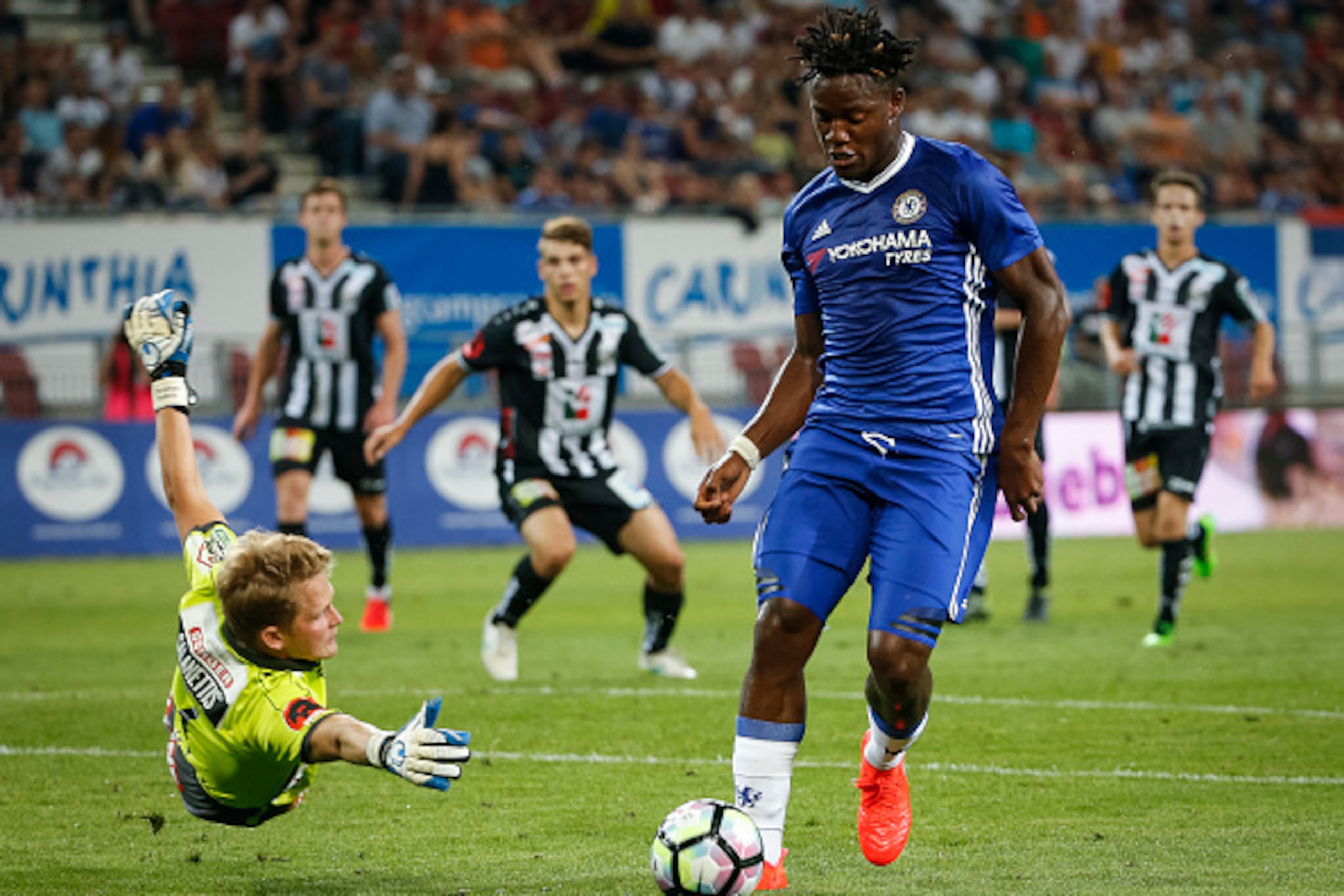 VELDEN, AUSTRIA - JULY 20: Michy Batshuayi (R) of Chelsea in action against goalkeeper Alexander Kofler (L) of WAC RZ Pellets during the friendly match between WAC RZ Pellets and Chelsea F.C. at Worthersee Stadion on July 20, 2016 in Velden, Austria. (Pho