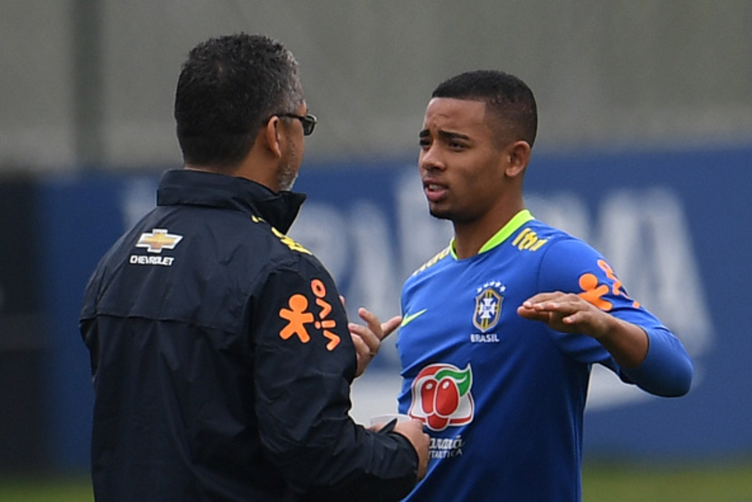 Brazilian Olympic football team player Gabriel Jesus(R) listens to Brazilian coach Rogelio Micale during a training session ahead of the Rio 2016 Olympic Games at the Granja Comary sport complex  in Teresopolis, about 90 km from Rio de Janeiro, Brazil, on