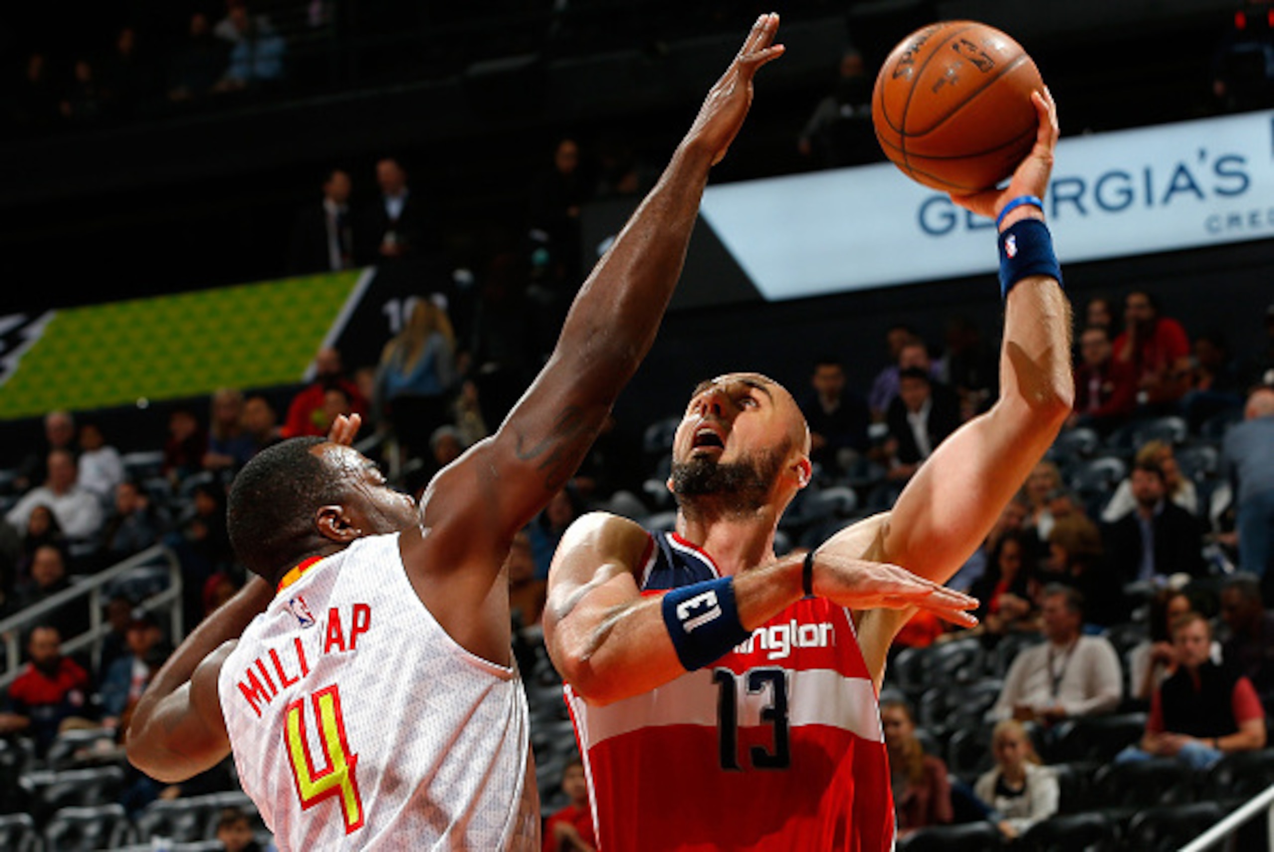 ATLANTA, GA - MARCH 21:  Marcin Gortat #13 of the Washington Wizards attempts a shot against Paul Millsap #4 of the Atlanta Hawks at Philips Arena on March 21, 2016 in Atlanta, Georgia.  NOTE TO USER User expressly acknowledges and agrees that, by downloa