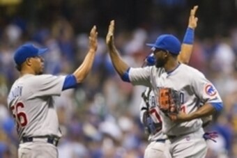 Jul 22, 2016; Milwaukee, WI, USA; Chicago Cubs center fielder Dexter Fowler (24) high fives teammates following the game against the Milwaukee Brewers at Miller Park.  Chicago won 5-2.  Mandatory Credit: Jeff Hanisch-USA TODAY Sports