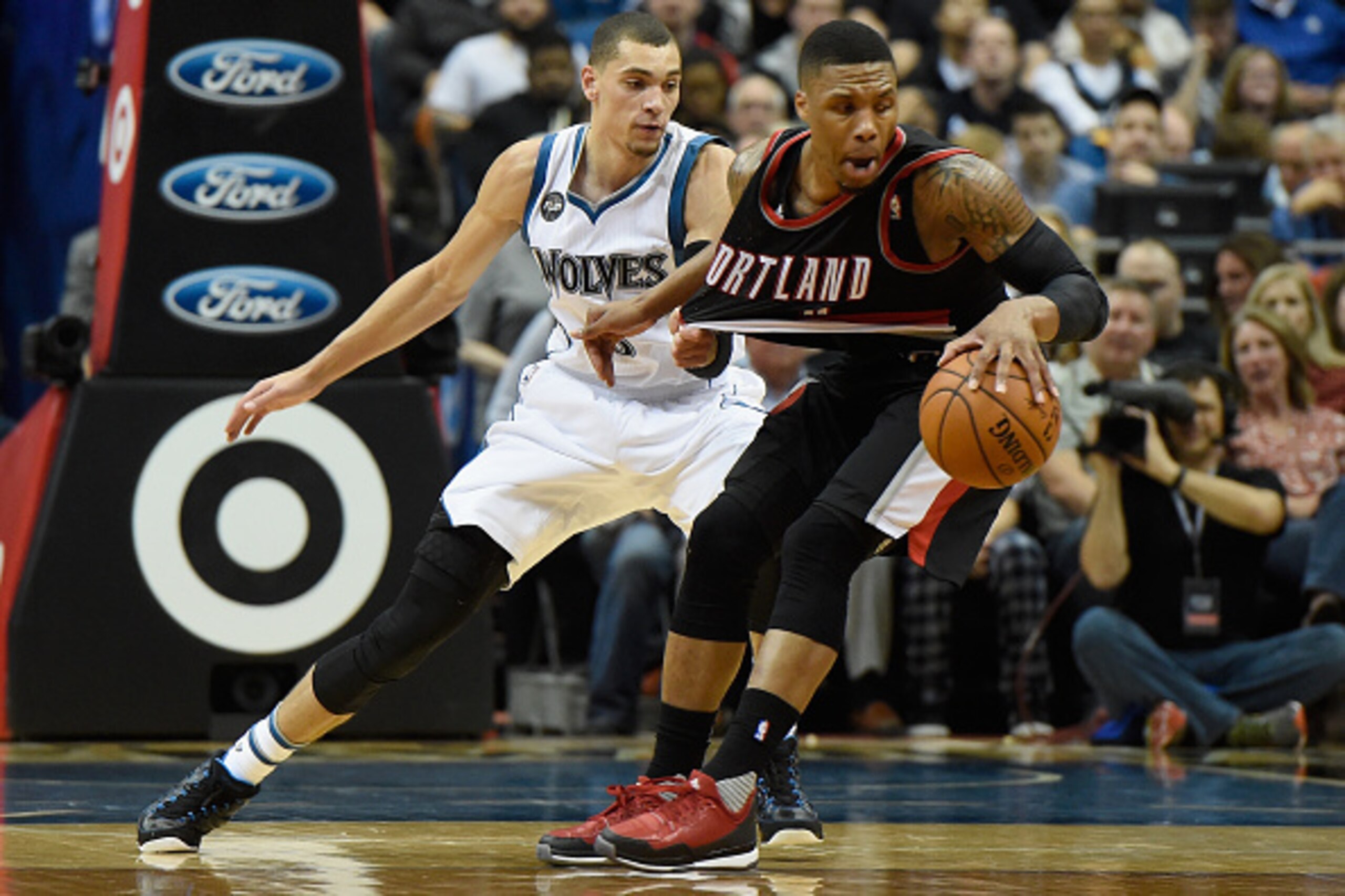 MINNEAPOLIS, MN - NOVEMBER 2: Zach LaVine #8 of the Minnesota Timberwolves guards against Damian Lillard #0 of the Portland Trail Blazers during the third quarter of the home opening game on November 2, 2015 at Target Center in Minneapolis, Minnesota. The