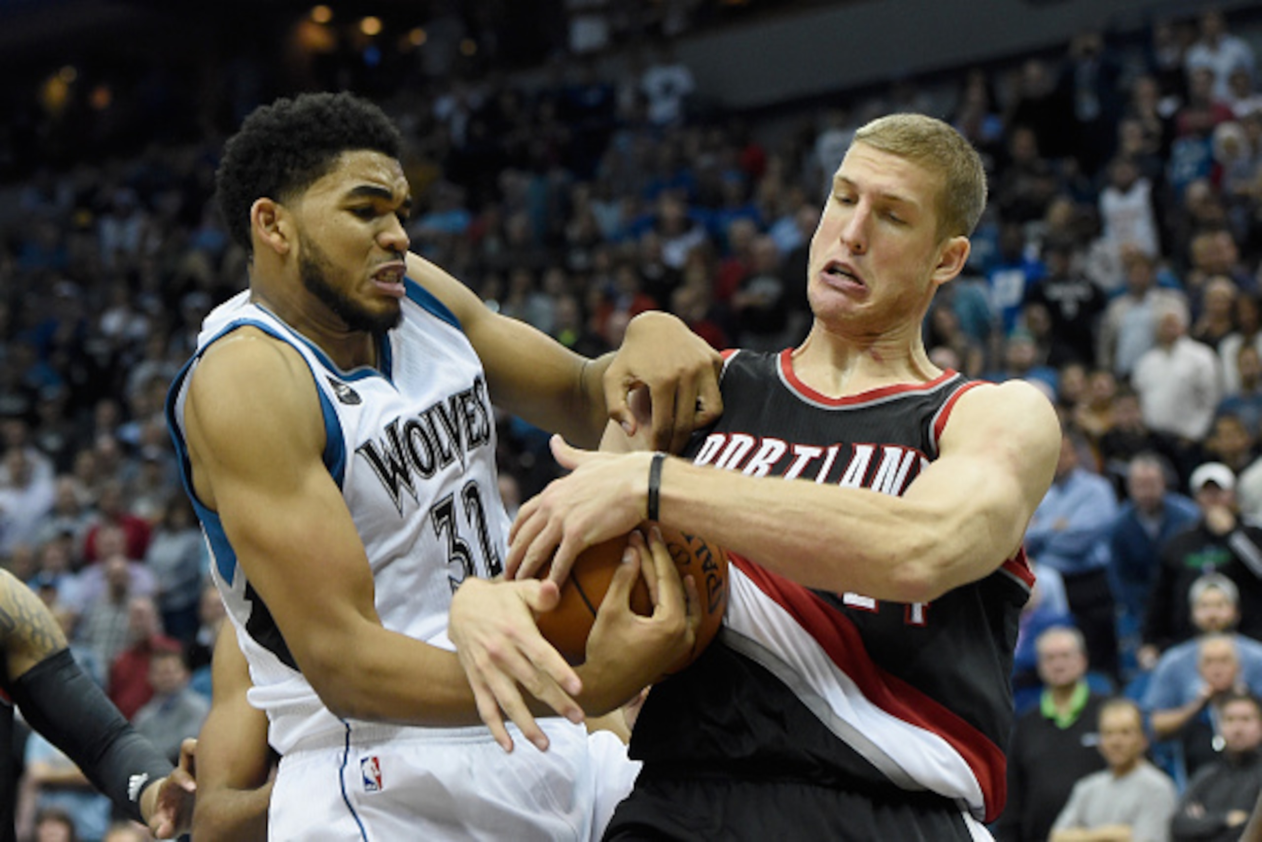 MINNEAPOLIS, MN - NOVEMBER 2:  Karl-Anthony Towns #32 of the Minnesota Timberwolves and Mason Plumlee #24 of the Portland Trail Blazers struggle over a jump ball in the fourth quarter of the home opening game on November 2, 2015 at Target Center in Minnea