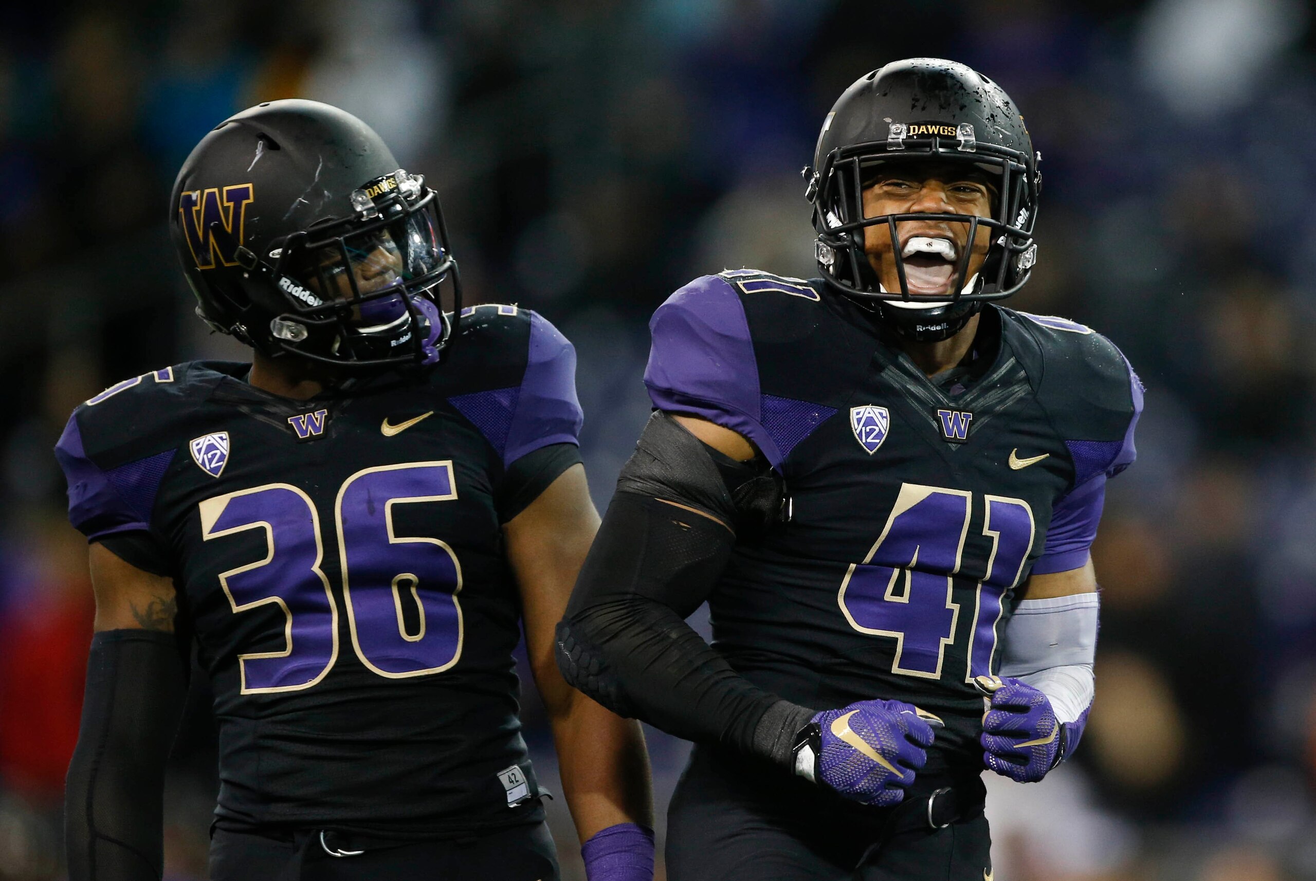 Oct 31, 2015; Seattle, WA, USA; Washington Huskies linebacker Azeem Victor (36) watches as linebacker Travis Feeney (41) celebrates a sack of Arizona Wildcats quarterback Anu Solomon (not pictured) during the second quarter at Husky Stadium. Mandatory Cre