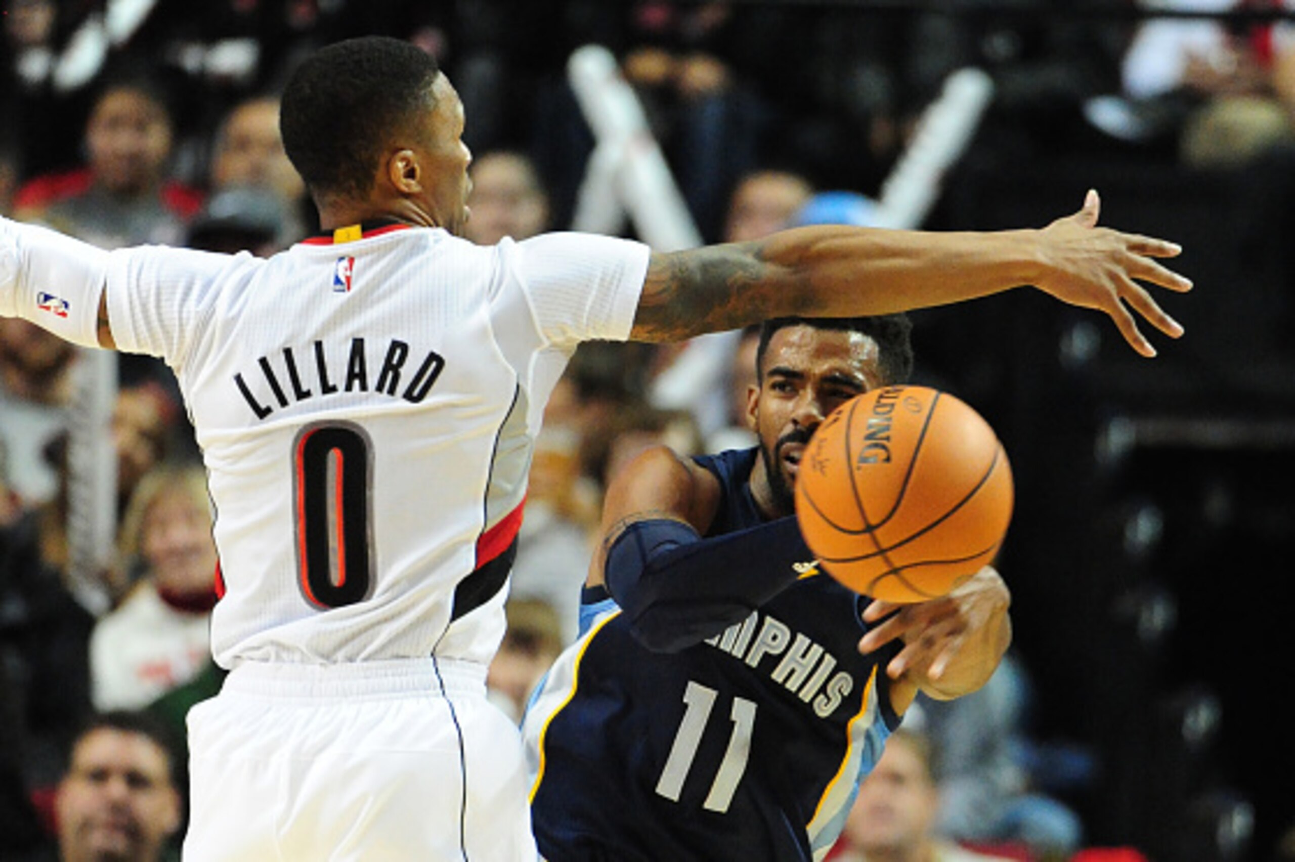 PORTLAND, OR - NOVEMBER 5: Mike Conley #11 of the Memphis Grizzlies passes the ball on Damian Lillard #0 of the Portland Trail Blazers during the third quarter of the game at Moda Center on November 5, 2015 in Portland, Oregon.  NOTE TO USER:  User expres