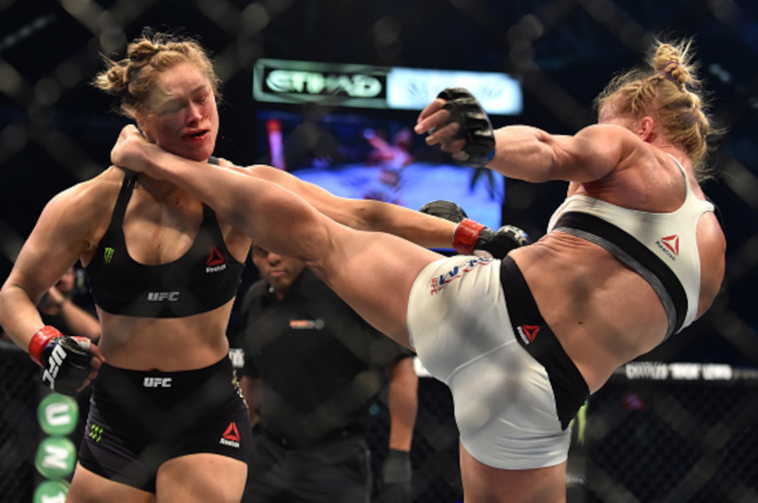 Holly Holm of the US (R) lands a kick to the neck to knock out compatriot Ronda Rousey and win the UFC title fight in Melbourne on November 15, 2015.   RESTRICTED TO EDITORIAL USE NO ADVERTISING USE NO PROMOTIONAL USE NO MERCHANDISING USE.   / AFP / PAUL 