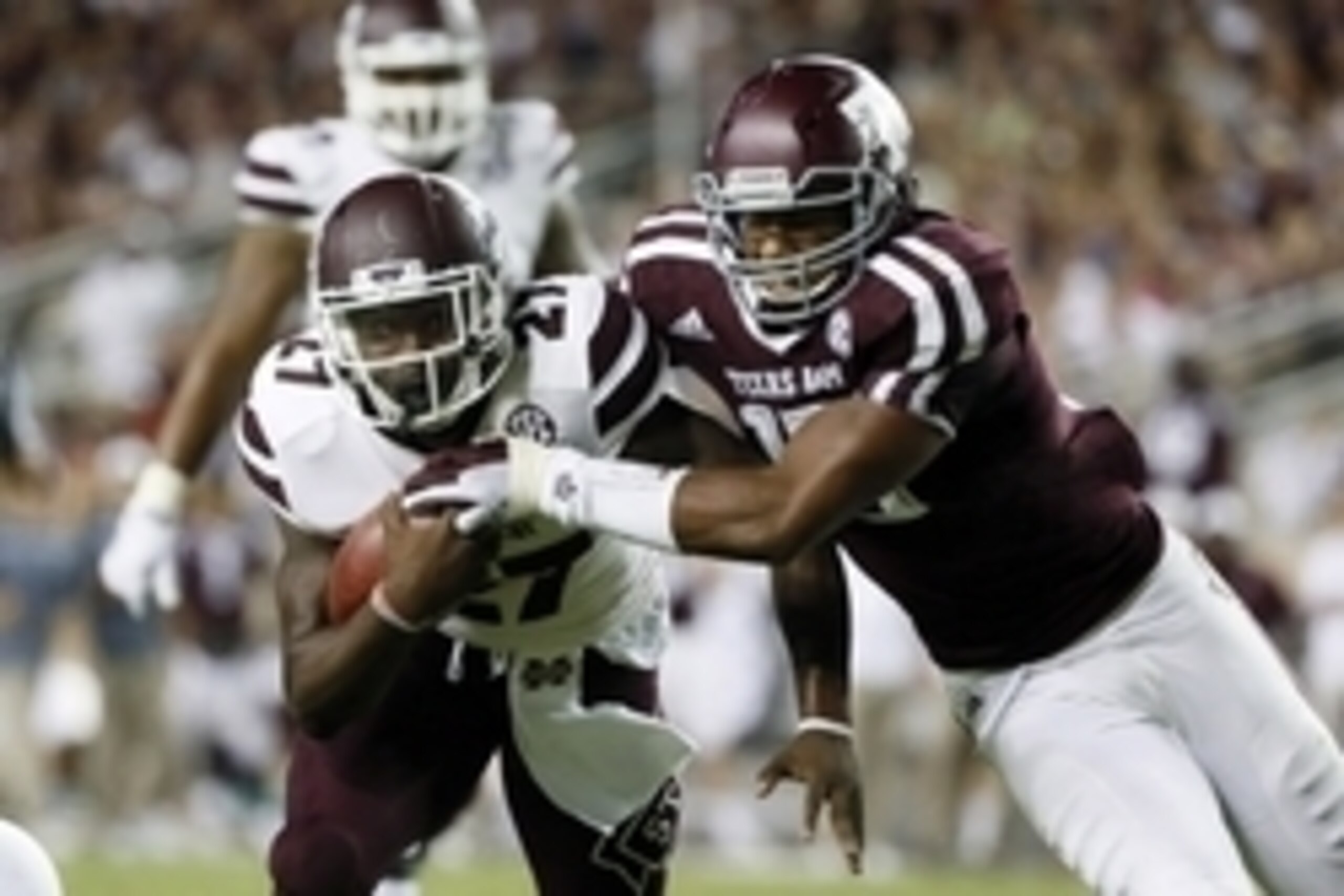 Oct 3, 2015; College Station, TX, USA; Mississippi State Bulldogs running back Aeris Williams (27) carries the ball as Texas A&M Aggies defensive lineman Myles Garrett (right) defends during the second half at Kyle Field. Texas A&M won 30-17. Mandatory Cr