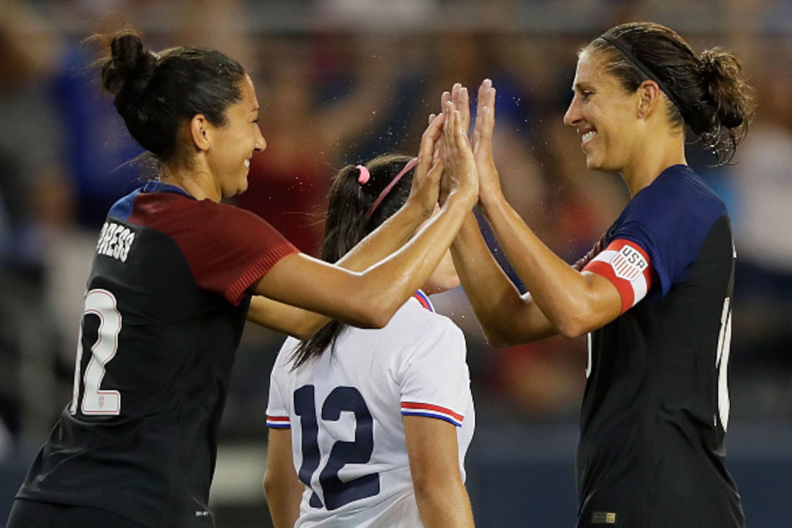 KANSAS CITY, KS - JULY 22:  Christen Press #12 of the United States is congratulated by Carli Lloyd #10 after scoring during the game against Costa Rica at Children's Mercy Park on July 22, 2016 in Kansas City, Kansas.  (Photo by Jamie Squire/Getty Images