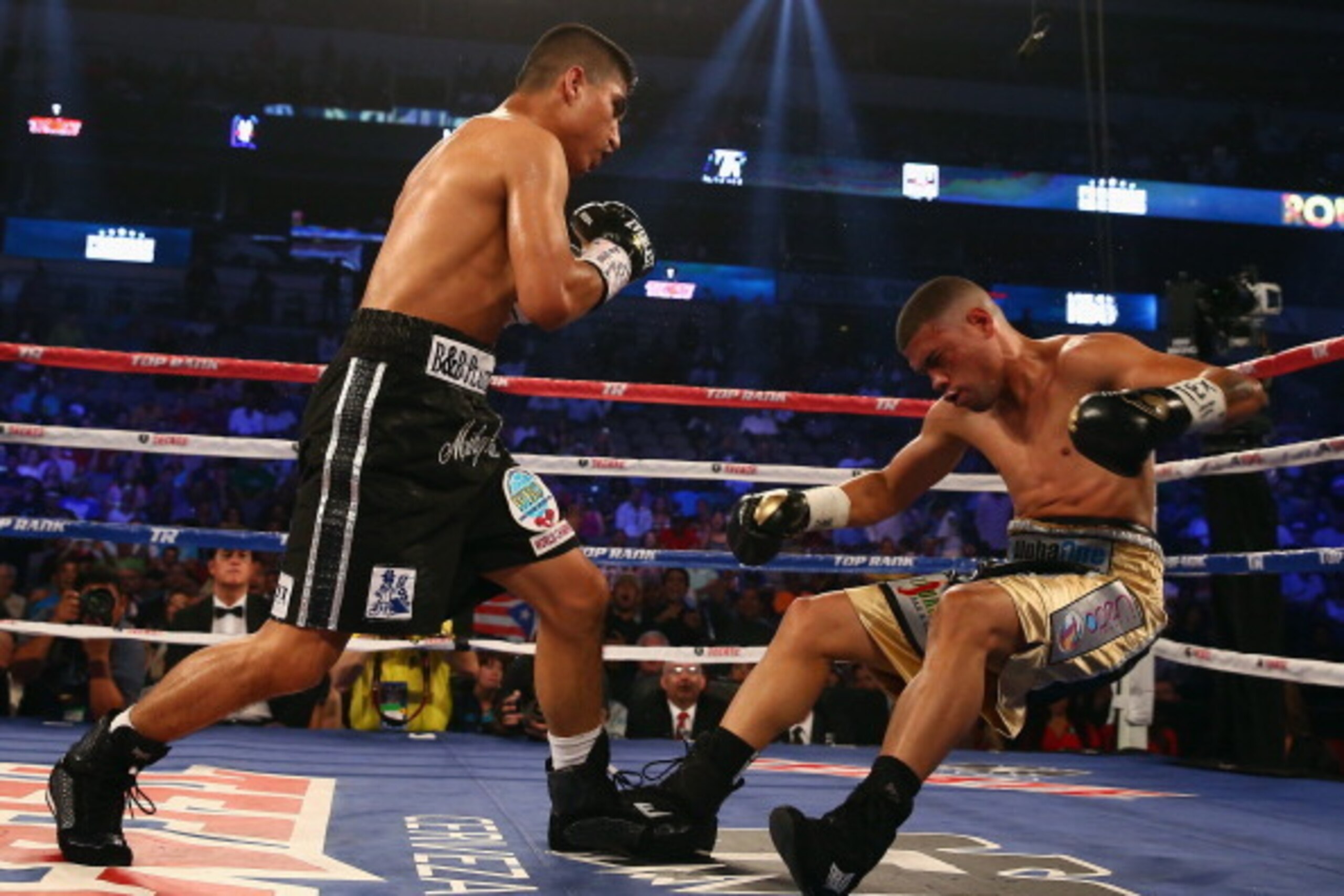 DALLAS, TX - JUNE 15:  (L-R) Mikey Garcia knocks out Juan Manuel Lopez in the fourth round during their Vacant WBO Featherweight Title bout at American Airlines Center on June 15, 2013 in Dallas, Texas.  (Photo by Tom Pennington/Getty Images)
