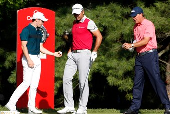 Jul 28, 2016; Springfield, NJ, USA; From left to right PGA golfers Rory McIlroy, Jason Day, and Phil Mickelson show each other their golf balls before teeing off on the 10th hole during the first round of the 2016 PGA Championship golf tournament at Baltu