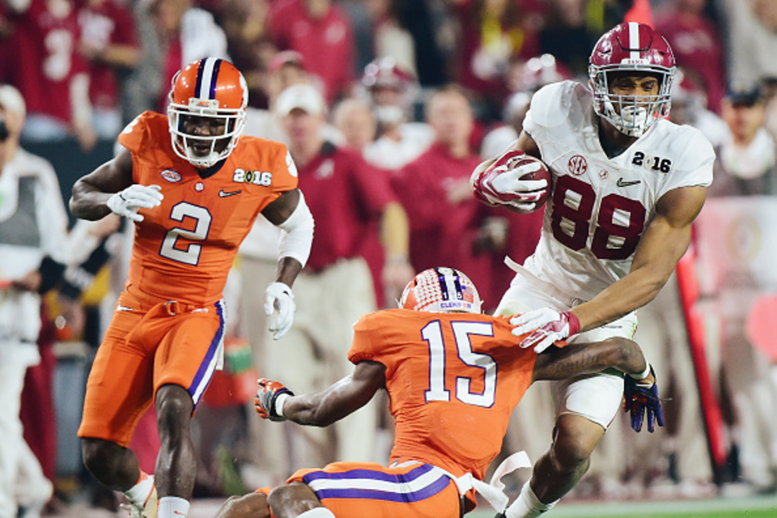 GLENDALE, AZ - JANUARY 11:  O.J. Howard #88 of the Alabama Crimson Tide runs with the ball against T.J. Green #15 of the Clemson Tigers during the 2016 College Football Playoff National Championship Game at University of Phoenix Stadium on January 11, 201