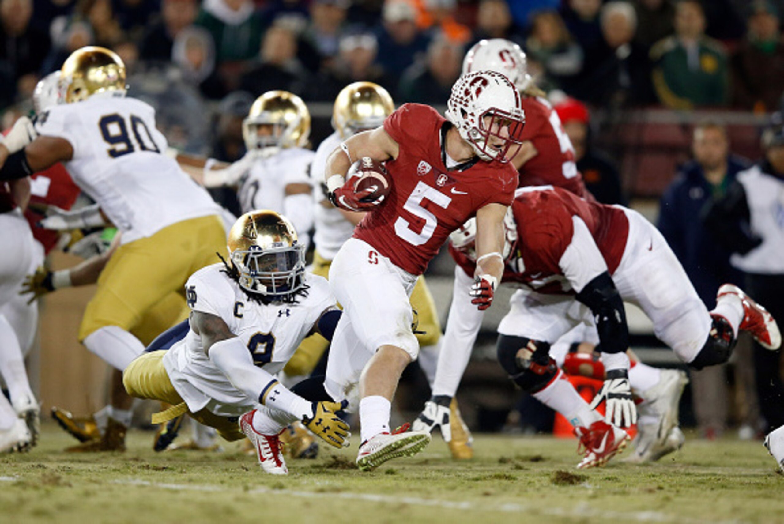PALO ALTO, CA - NOVEMBER 28:  Christian McCaffrey #5 of the Stanford Cardinal is tackled by Jaylon Smith #9 of the Notre Dame Fighting Irish at Stanford Stadium on November 28, 2015 in Palo Alto, California.  (Photo by Ezra Shaw/Getty Images)