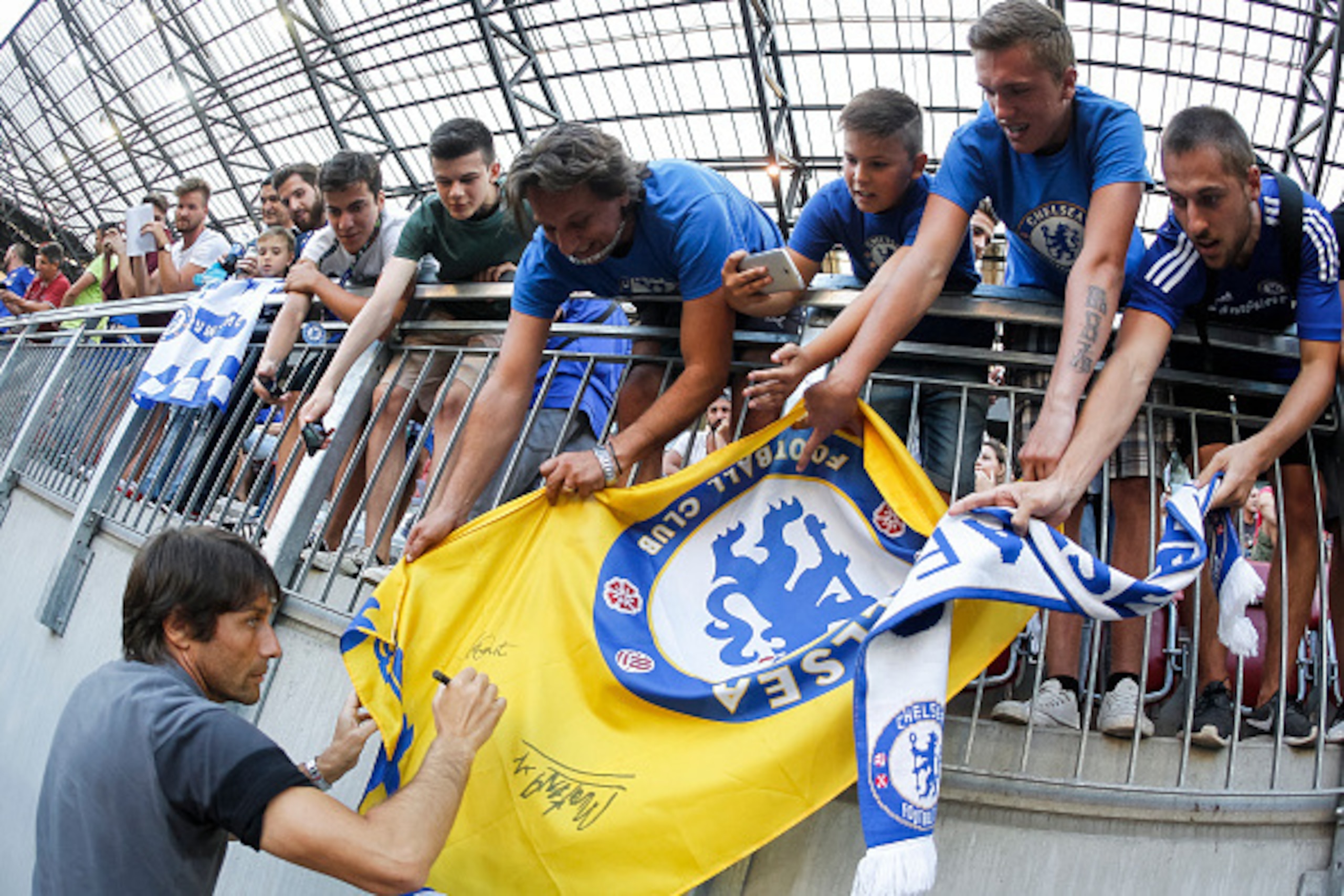 VELDEN, AUSTRIA - JULY 20:  Head coach Antonio Conte (L) of Chelsea gives an autograph to fans prior the international friendly match between WAC RZ Pellets and Chelsea F.C. at Worthersee Stadion on July 20, 2016 in Velden, Austria. (Photo by Srdjan Steva