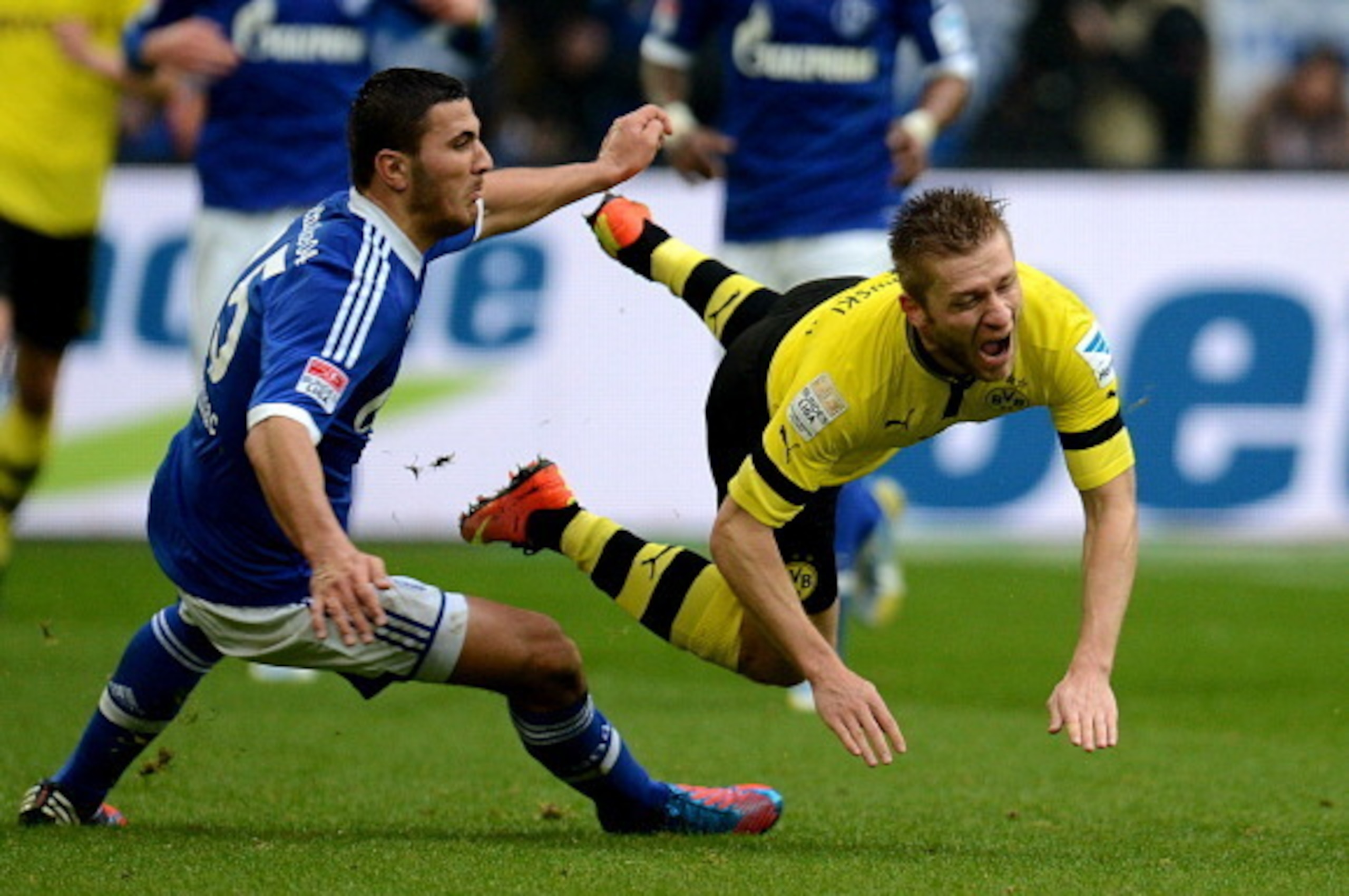 Schalke's defender Sead Kolasinac and Dortmund's Polish midfielder Jakub Blaszczykowski vie for the ball during the German first division Bundesliga football match FC Schalke 04 vs Borussia Dortmund in the German city of Gelsenkirchen on March 9, 2013. AF