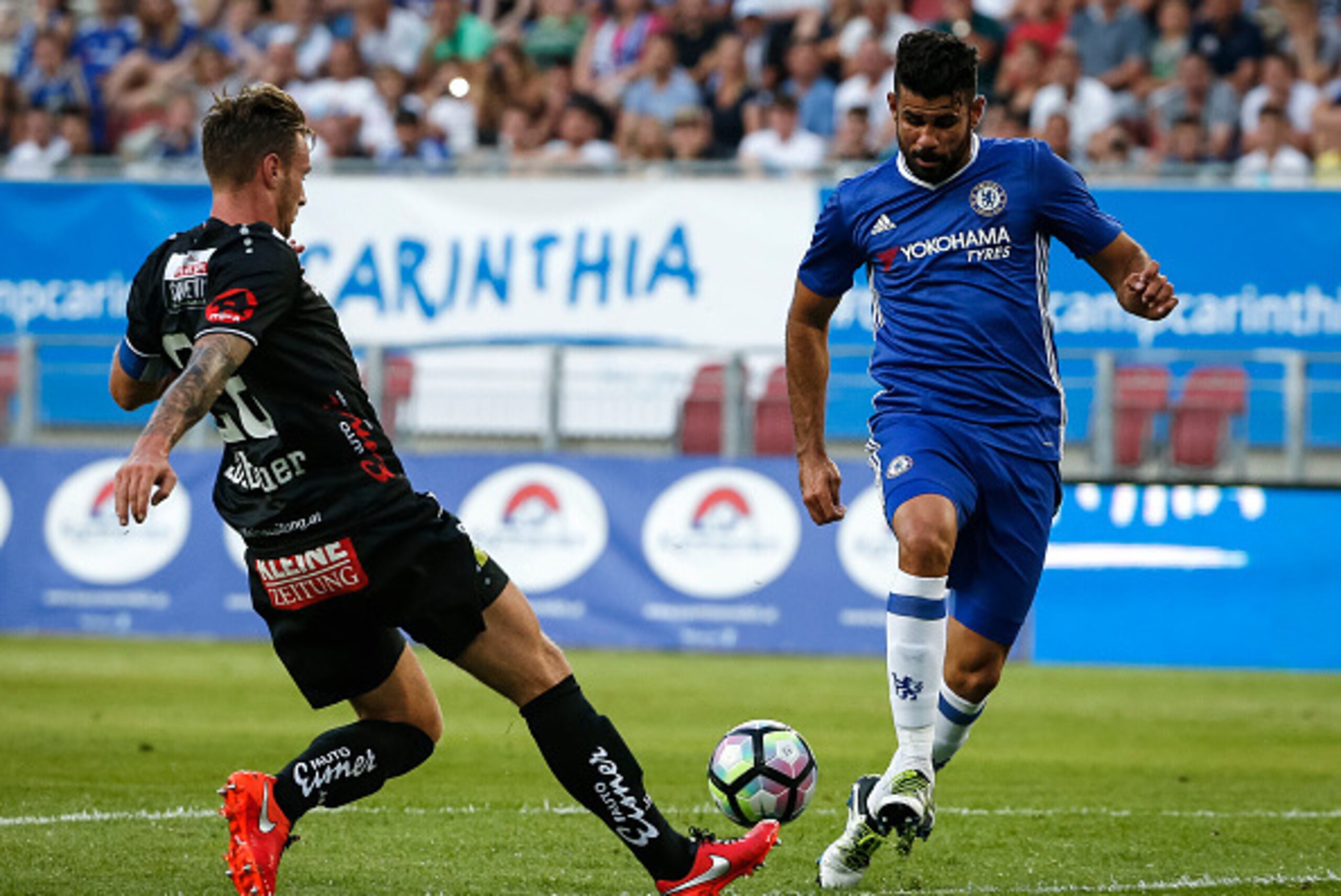 VELDEN, AUSTRIA - JULY 20:  Diego Costa (R) of Chelsea in action against Michael Sollbauer (L) of WAC RZ Pellets during the friendly match between WAC RZ Pellets and Chelsea F.C. at Worthersee Stadion on July 20, 2016 in Velden, Austria. (Photo by Srdjan 