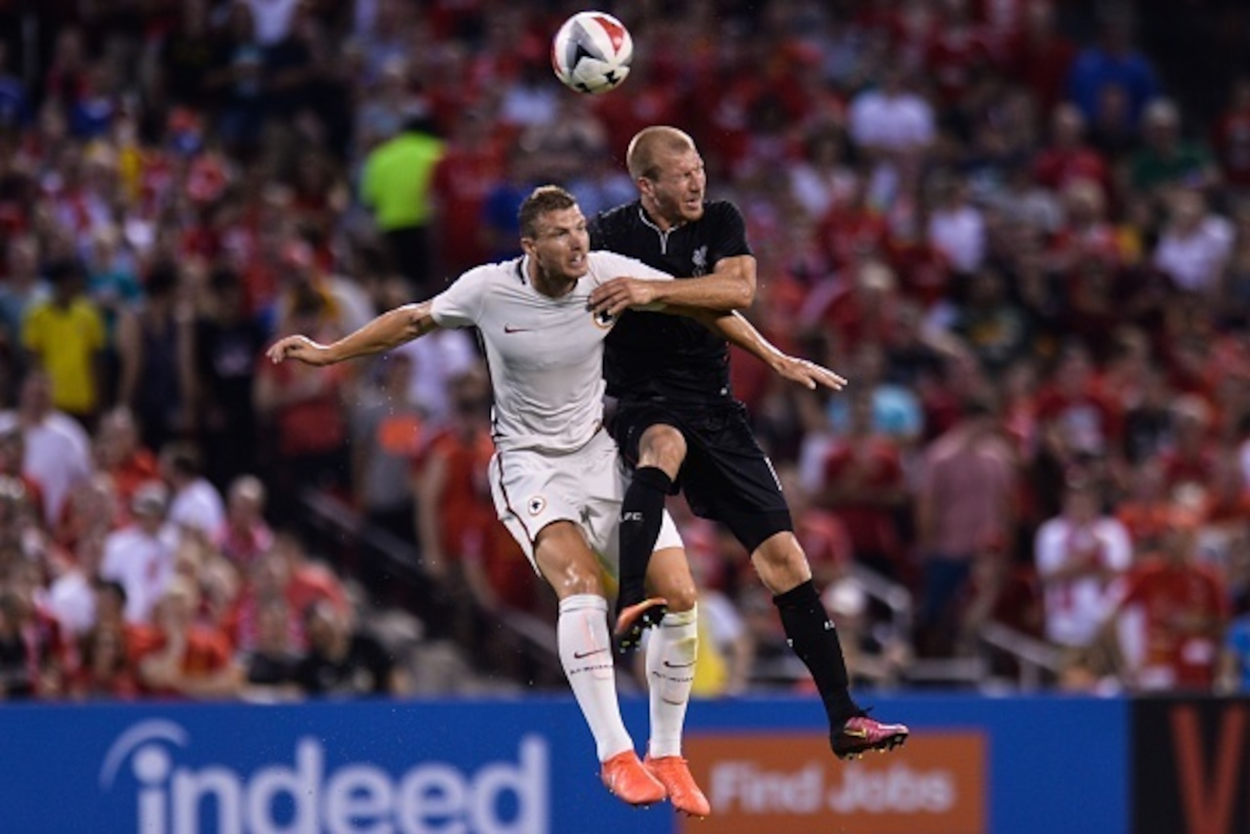 Roma forward Edin Dzeko (9) heads the ball against Liverpool defender Ragnar Klavan (17) during their friendly soccer match at Busch Stadium in St. Louis, Missouri on August 1, 2016. / AFP / Michael B. Thomas        (Photo credit should read MICHAEL B. TH