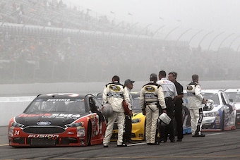 LONG POND, PA - AUGUST 01:  Chris Buescher, driver of the #34 Dockside Logistics Ford, leads the field as they park on pit road for a weather-related red flag during the NASCAR Sprint Cup Series Pennsylvania 400 at Pocono Raceway on August 1, 2016 in Long