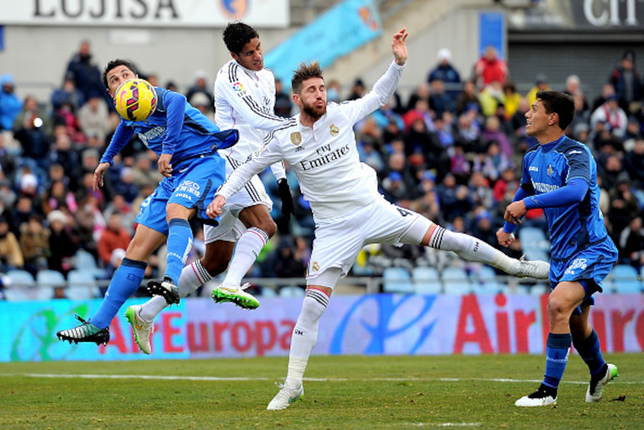 GETAFE, SPAIN - JANUARY 18: Sergio Ramos and Raphael Varane of of Real Madrid battle for the ball against Roberto Lago of Getafe CF during the La Liga match between Getafe CF and Real Madrid CF at Coliseum Alfonso Perez stadium on January 18, 2015 in Geta