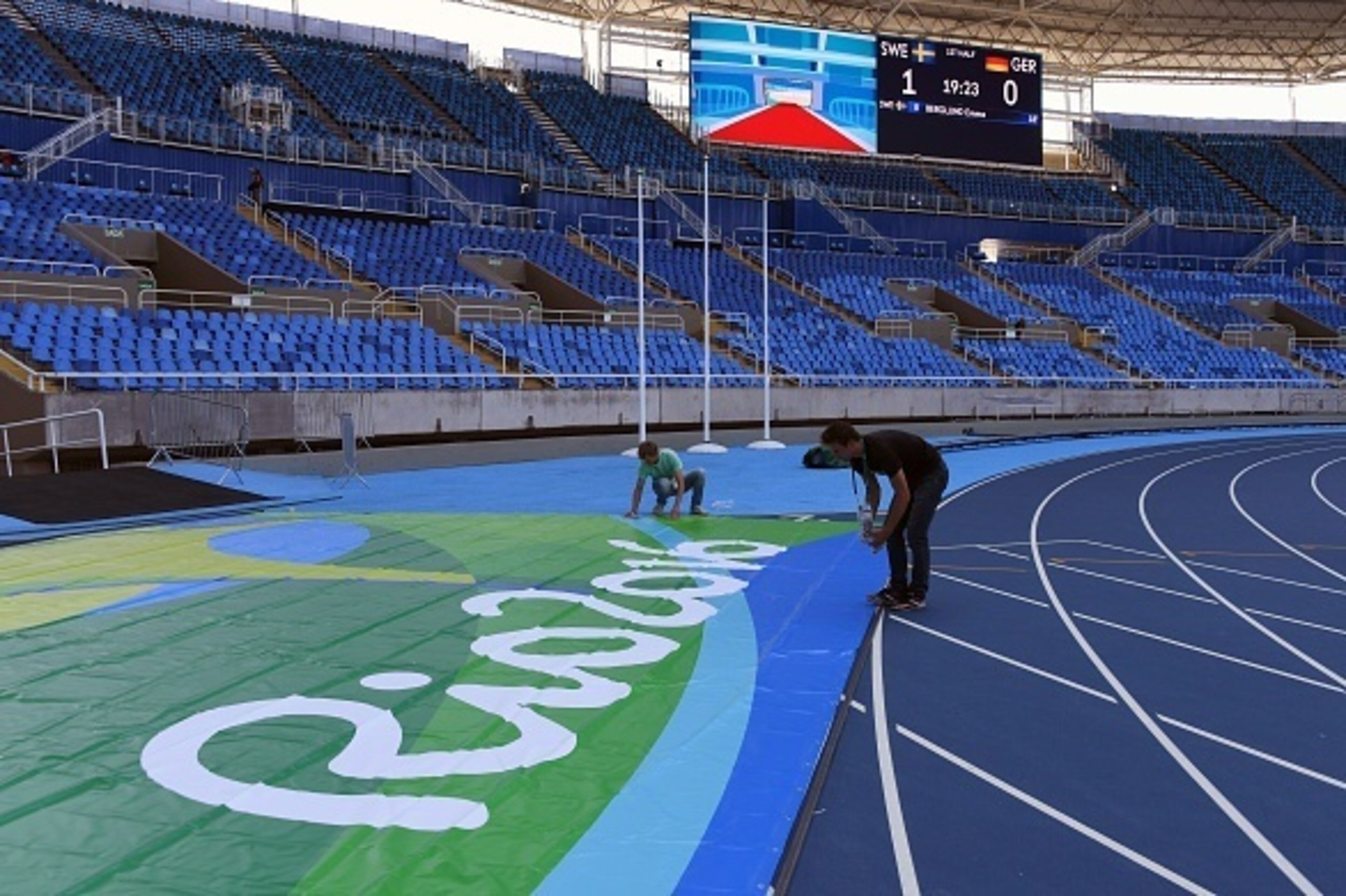 Workers apply the finishing touches to the Olympic Stadium in Rio de Janeiro on August 2, 2016, ahead of the Rio 2016 Olympic Games. / AFP / VANDERLEI ALMEIDA (Photo credit should read VANDERLEI ALMEIDA/AFP/Getty Images) Workers apply the finishing touches to the Olympic Stadium in Rio de Janeiro on August 2, 2016, ahead of the Rio 2016 Olympic Games. / AFP / VANDERLEI ALMEIDA (Photo credit should read VANDERLEI ALMEIDA/AFP/Getty Images)