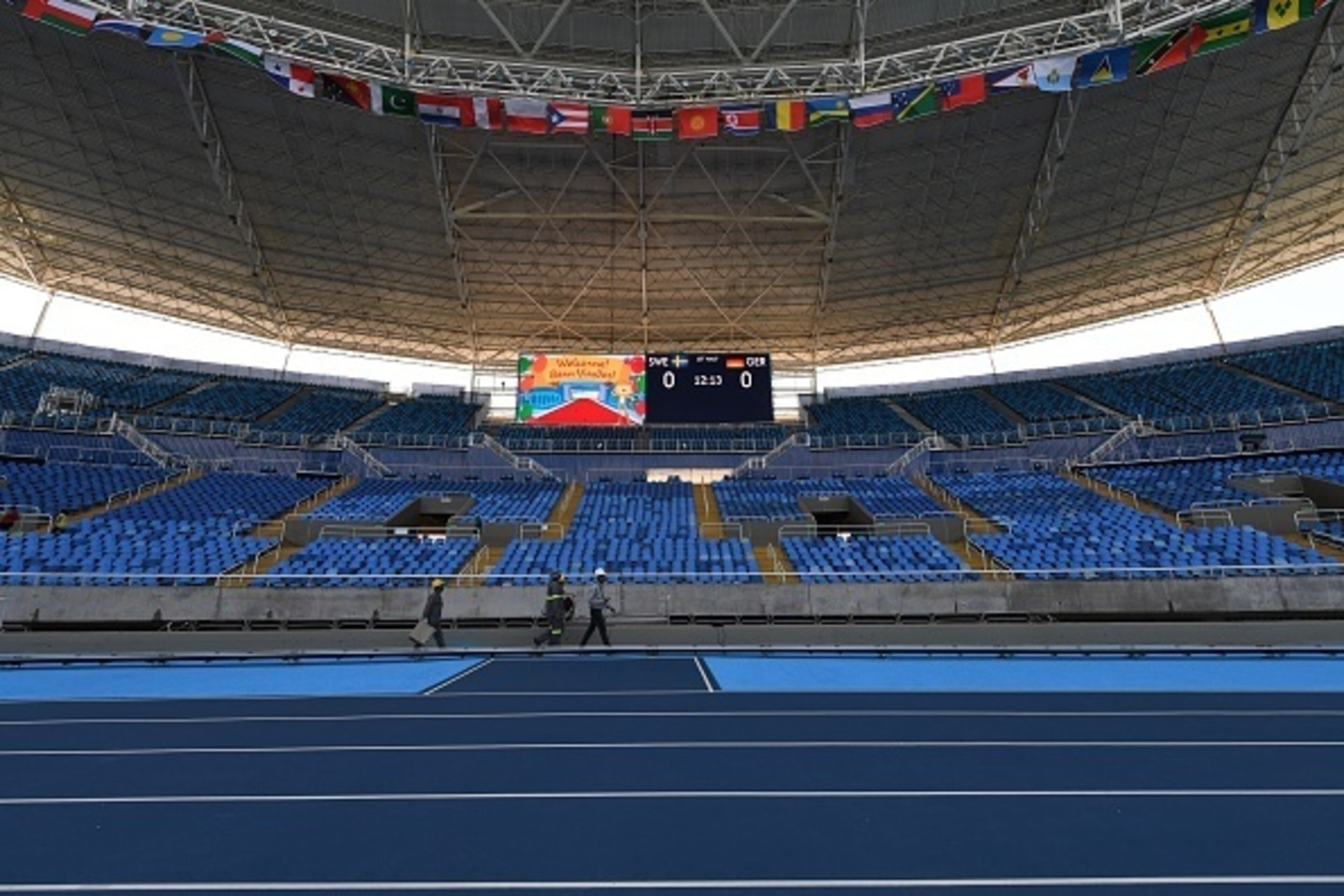 Workers apply the finishing touches to the Olympic Stadium in Rio de Janeiro on August 2, 2016, ahead of the Rio 2016 Olympic Games. / AFP / VANDERLEI ALMEIDA (Photo credit should read VANDERLEI ALMEIDA/AFP/Getty Images) Workers apply the finishing touches to the Olympic Stadium in Rio de Janeiro on August 2, 2016, ahead of the Rio 2016 Olympic Games. / AFP / VANDERLEI ALMEIDA (Photo credit should read VANDERLEI ALMEIDA/AFP/Getty Images)