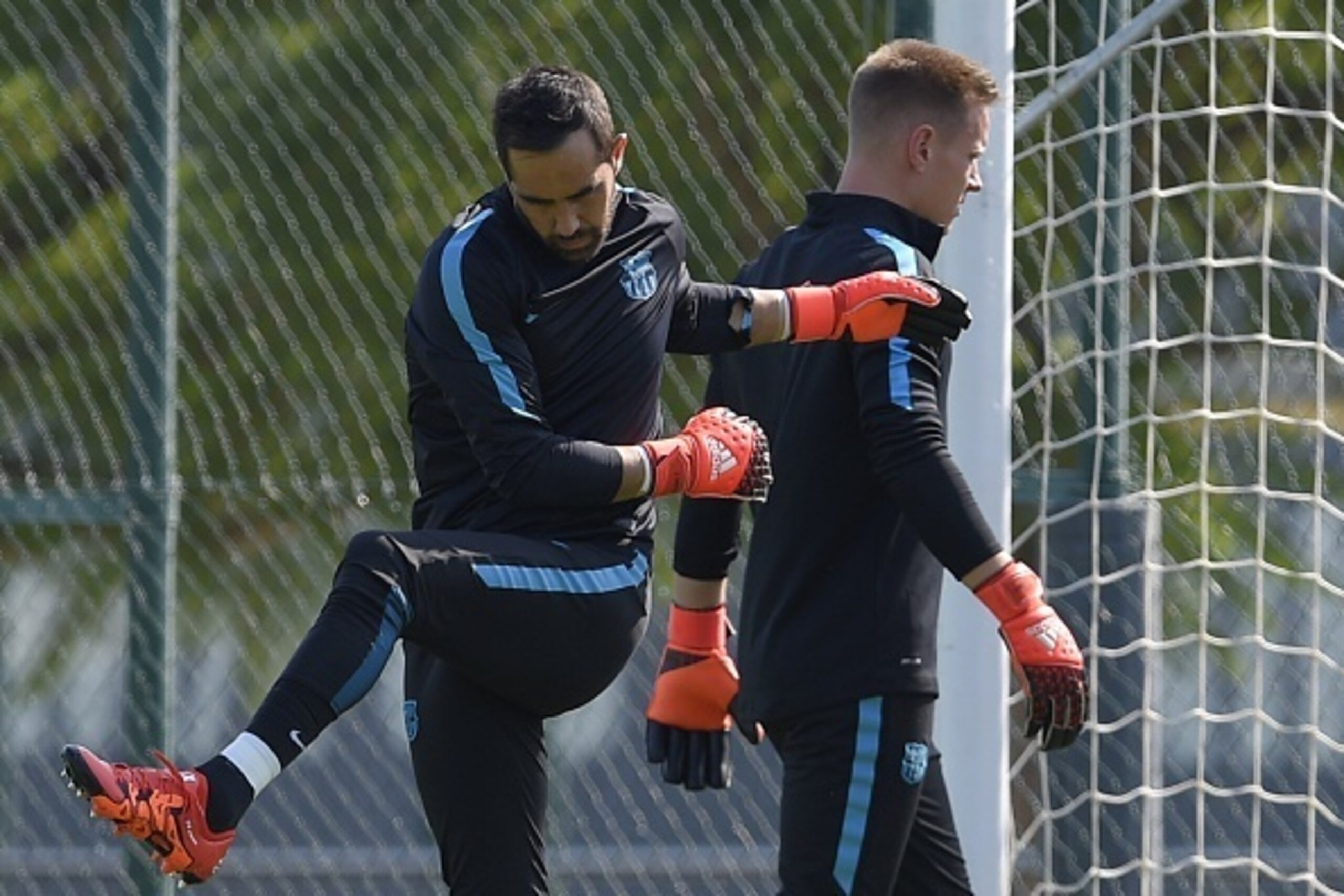 Barcelona's Chilean goalkeeper Claudio Bravo (L) and Barcelona's German goalkeeper Marc-Andre Ter Stegen (R) take part in a training session at the Sports Center FC Barcelona Joan Gamper in Sant Joan Despi, near Barcelona on September 28, 2015, on the eve