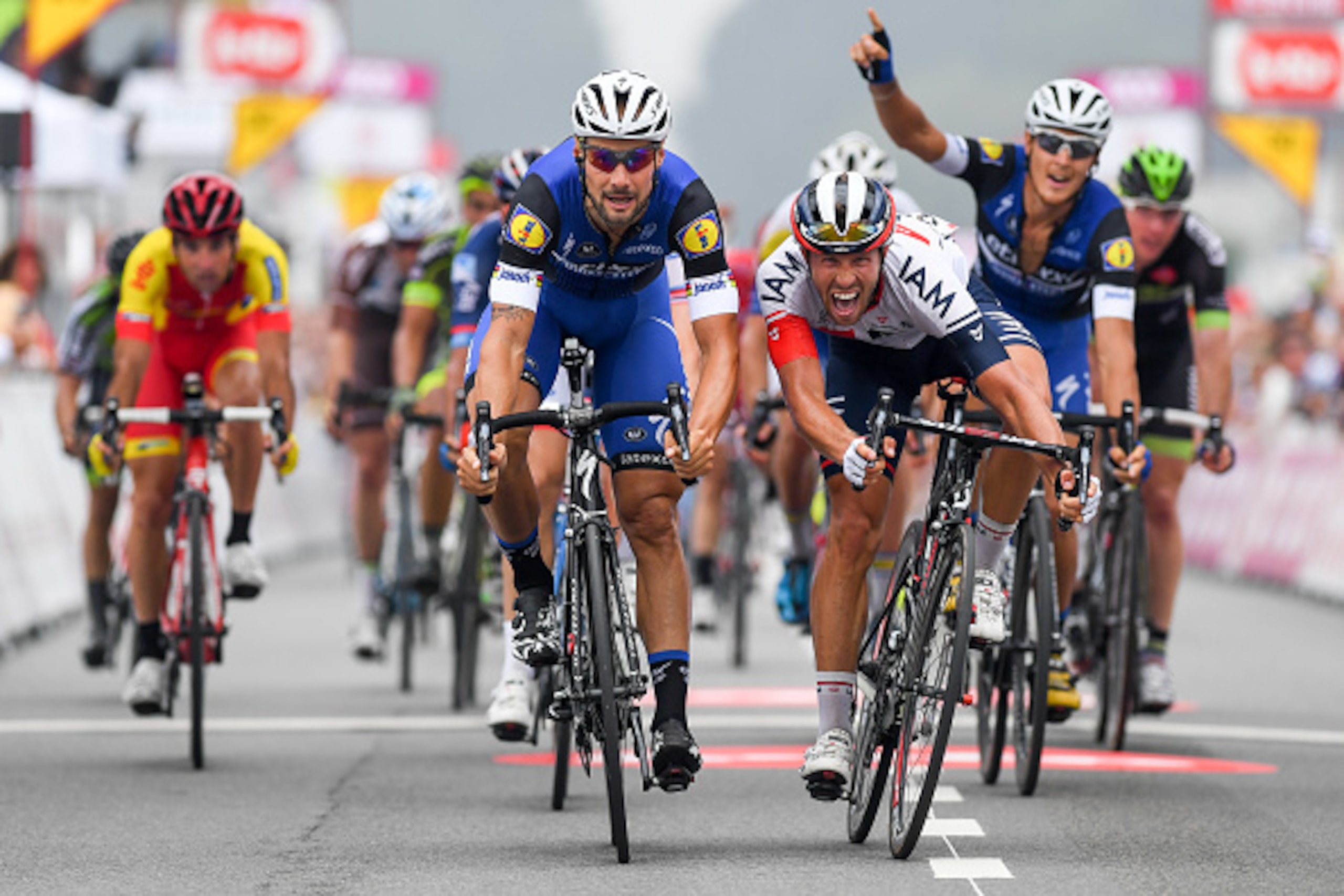 Belgian Tom Boonen of team Etixx - Quick-Step (L) wins ahead of Belgian Jonas Van Genechten of IAM Cycling (R) the sprint on the finish line of the first stage of the Tour De Wallonie cycling race from Charleroi to Mettet, on July 23, 2016. / AFP / BELGA 