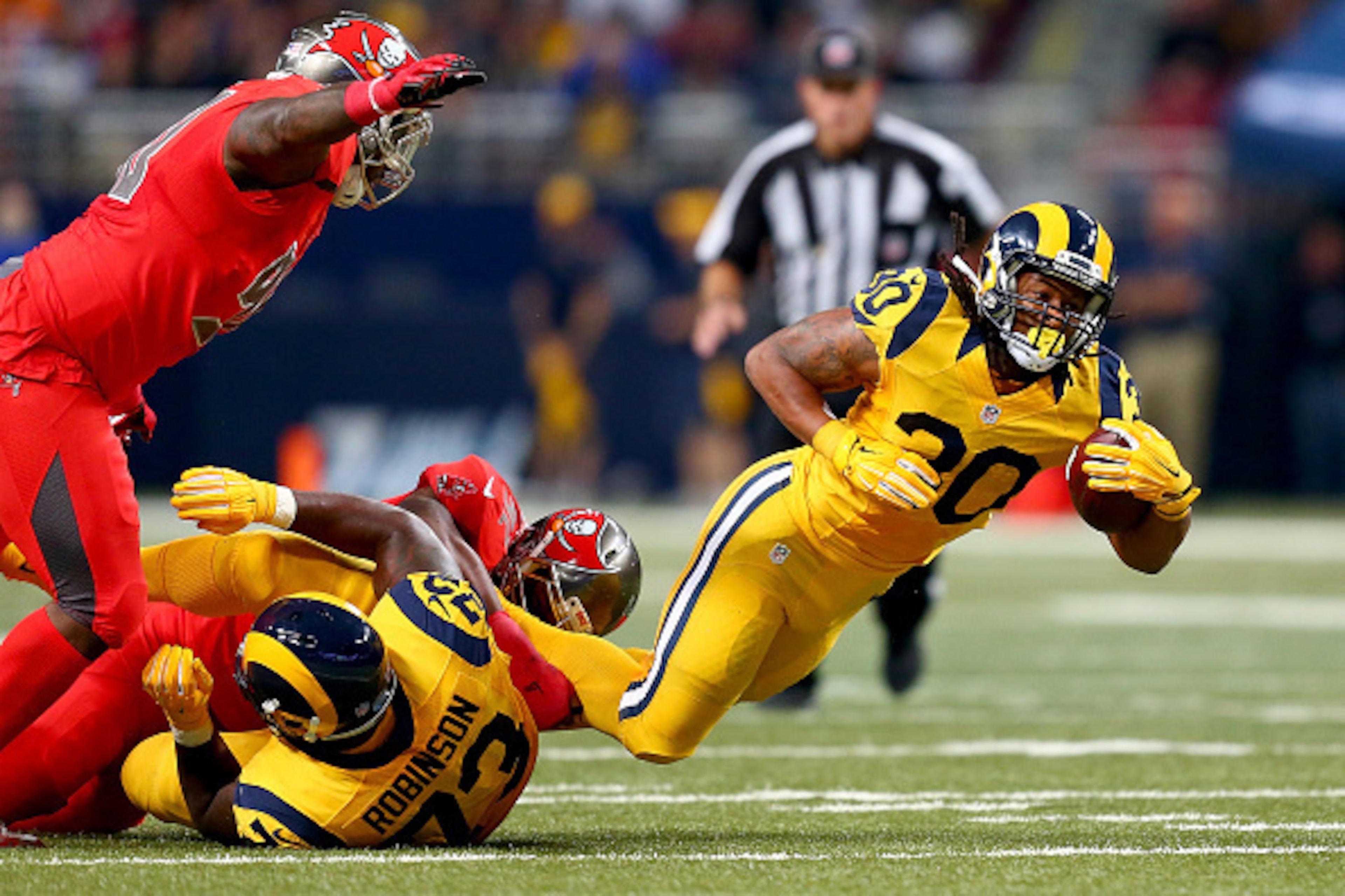 ST. LOUIS, MO - DECEMBER 17: Todd Gurley #30 of the St. Louis Rams is tripped up as he carries the ball in the second quarter against the Tampa Bay Buccaneers at the Edward Jones Dome on December 17, 2015 in St. Louis, Missouri. (Photo by Dilip Vishwanat/ ST. LOUIS, MO - DECEMBER 17: Todd Gurley #30 of the St. Louis Rams is tripped up as he carries the ball in the second quarter against the Tampa Bay Buccaneers at the Edward Jones Dome on December 17, 2015 in St. Louis, Missouri. (Photo by Dilip Vishwanat/