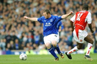 LIVERPOOL - 19 OCTOBER:  Wayne Rooney of Everton takes on Lauren of Arsenal during the FA Barclaycard Premiership match between Everton and Arsenal at Goodison Park in Liverpool on October 19, 2002. Everton won 2-1. (photo by Shaun Botterill/Getty Images.