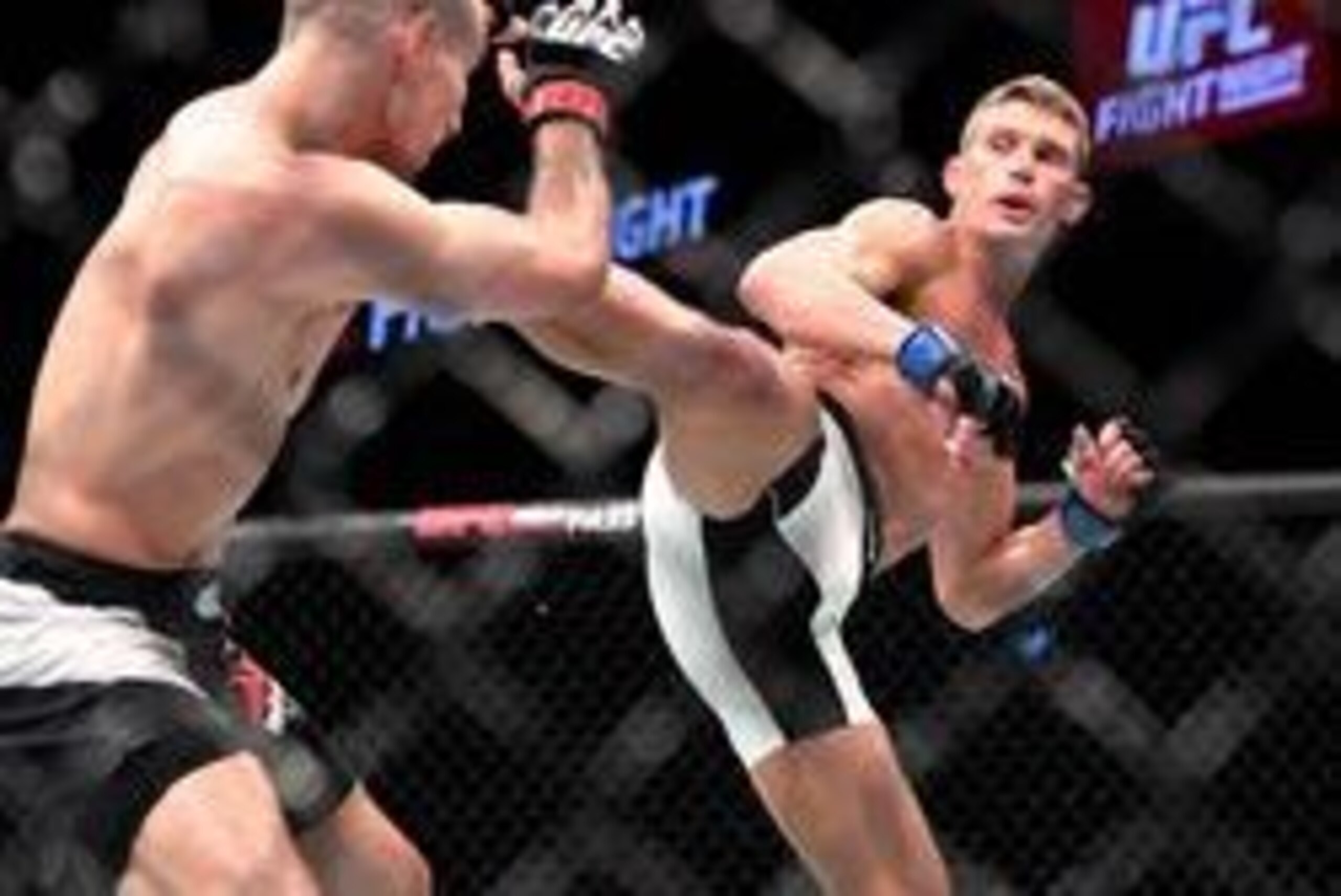 Jun 18, 2016; Ottawa, Ontario, Canada; Stephen Thompson (blue gloves) fights Rory MacDonald (red gloves) in the third round of a welterweight bout during UFC Fight Night at TD Place Arena. Mandatory Credit: Marc DesRosiers-USA TODAY Sports