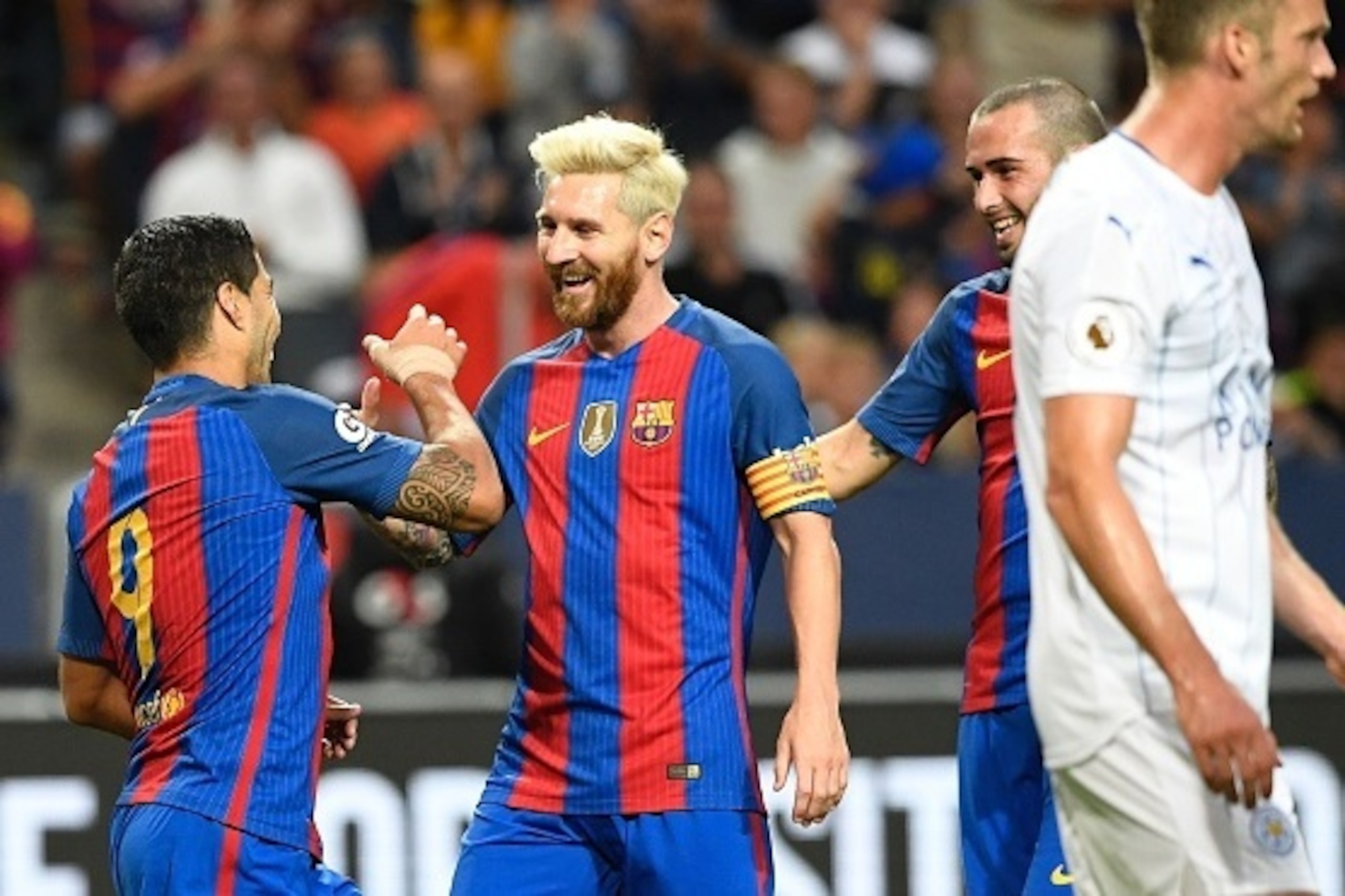 Barcelona's Uruguayan forward Luis Suarez (L) celebrates with his teammate Argentinian forward Lionel Messi after scoring a goal during the 2016 International Champions Cup football match between FC Barcelona and Leicester City at Friends Arena on August 