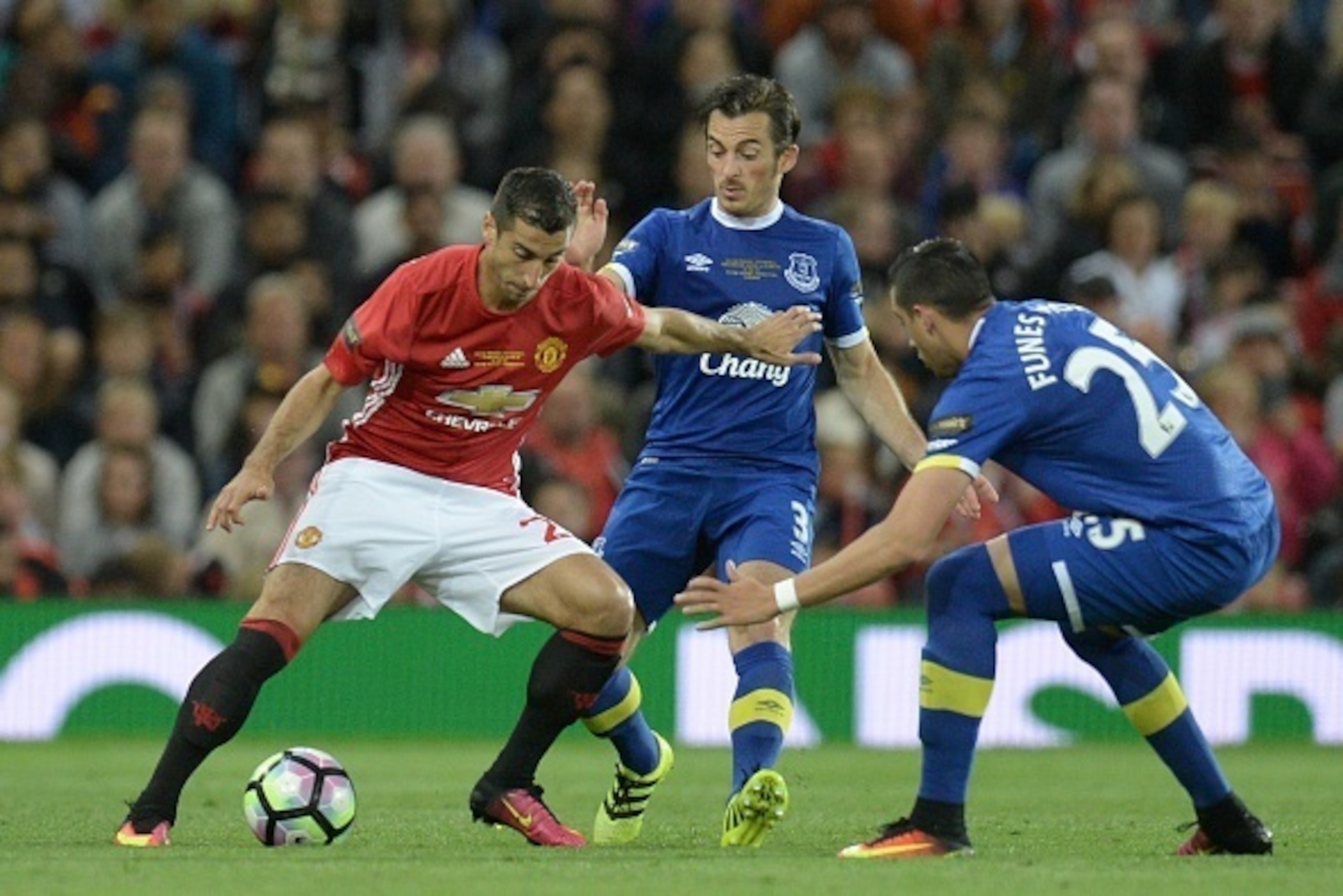 Manchester United's Armenian midfielder Henrikh Mkhitaryan (L) takes on Everton's English defender Leighton Baines (C) and Everton's Argentinian defender Ramiro Funes Mori (R) during the friendly Wayne Rooney testimonial football match between Manchester 