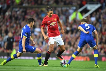 MANCHESTER, ENGLAND - AUGUST 03: Zlatan Ibrahimovic of Manchester United takes on John Stones and Gareth Barry of Everton during the Wayne Rooney Testimonial match between Manchester United and Everton at Old Trafford on August 3, 2016 in Manchester, Engl