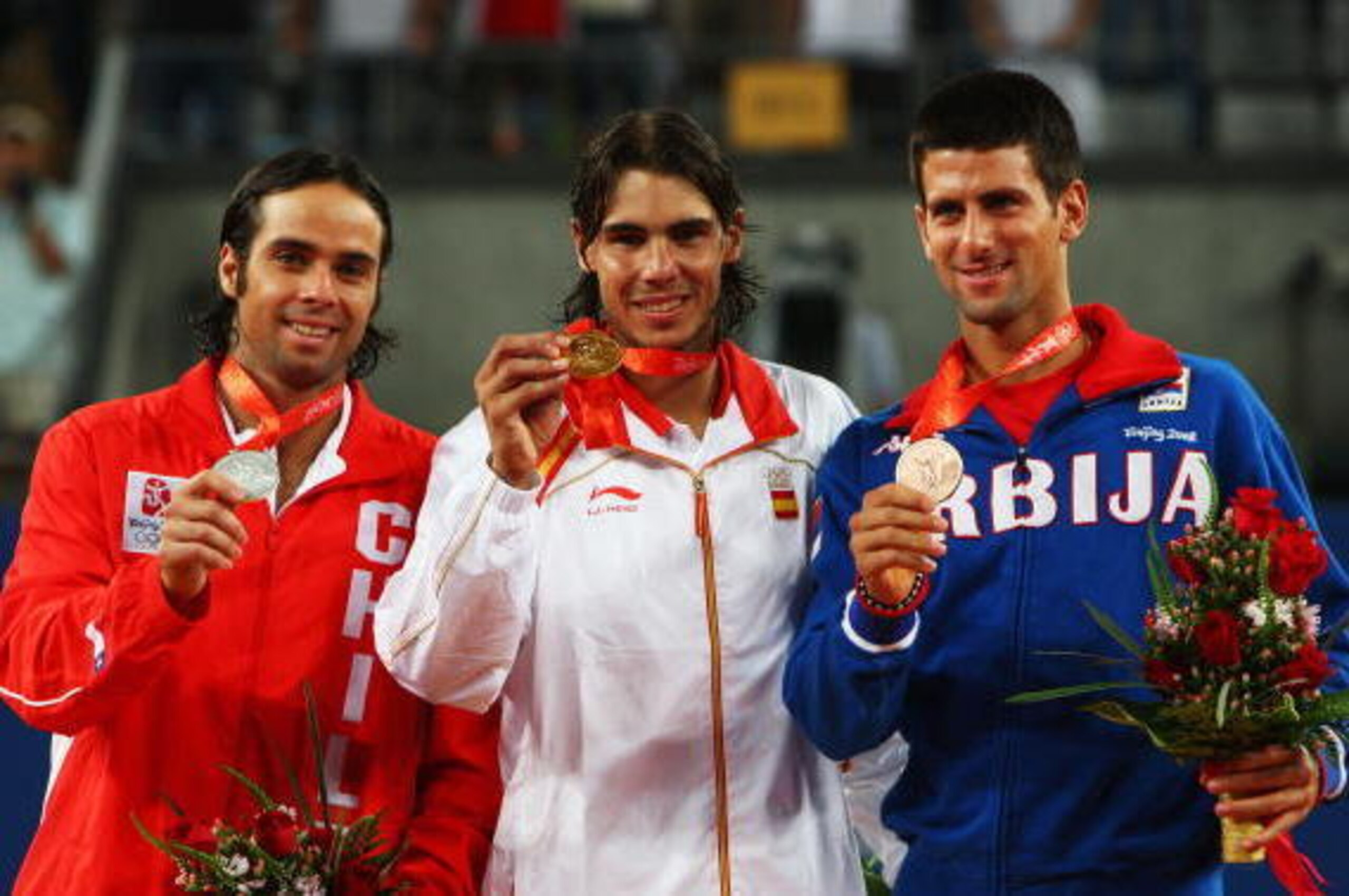 BEIJING - AUGUST 17:  Rafael Nadal (C) of Spain celebrates winning the gold medal with silver medalist Fernando Gonzalez (L) of Chile and bronze medalist Novak Djokovic of Serbia after the men's singles gold medal tennis match held at the Olympic Green Te