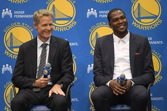 OAKLAND, CA - JULY 07:  (L-R) Head coach Steve Kerr of the Golden State Warriors sits with Kevin Durant while they speak to the media during the press conference where Durant was introduced as a Golden State Warrior after they signed him as a free agent o