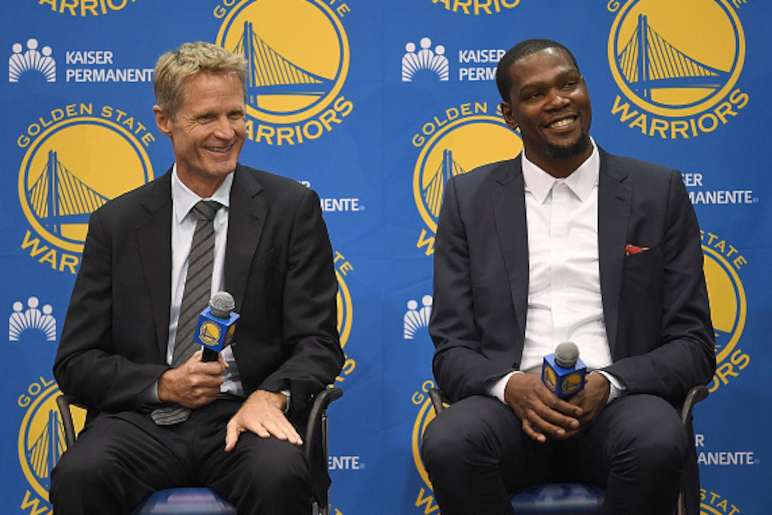 OAKLAND, CA - JULY 07:  (L-R) Head coach Steve Kerr of the Golden State Warriors sits with Kevin Durant while they speak to the media during the press conference where Durant was introduced as a Golden State Warrior after they signed him as a free agent o