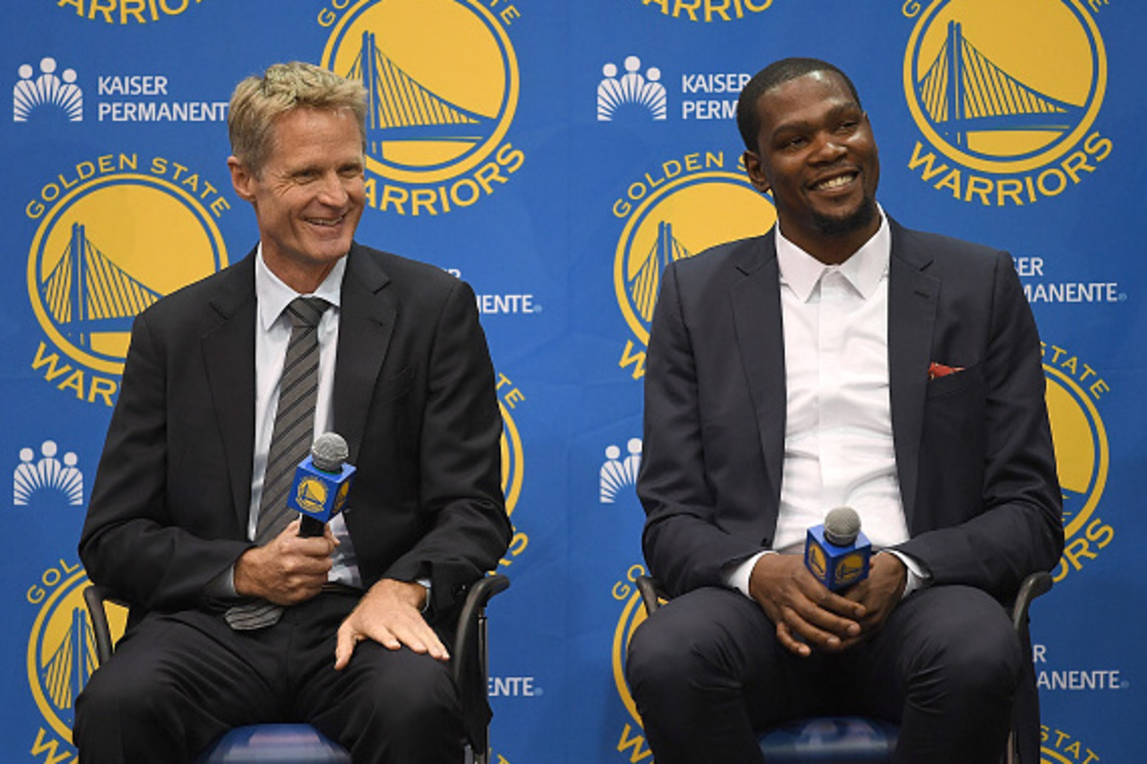 OAKLAND, CA - JULY 07:  (L-R) Head coach Steve Kerr of the Golden State Warriors sits with Kevin Durant while they speak to the media during the press conference where Durant was introduced as a Golden State Warrior after they signed him as a free agent o