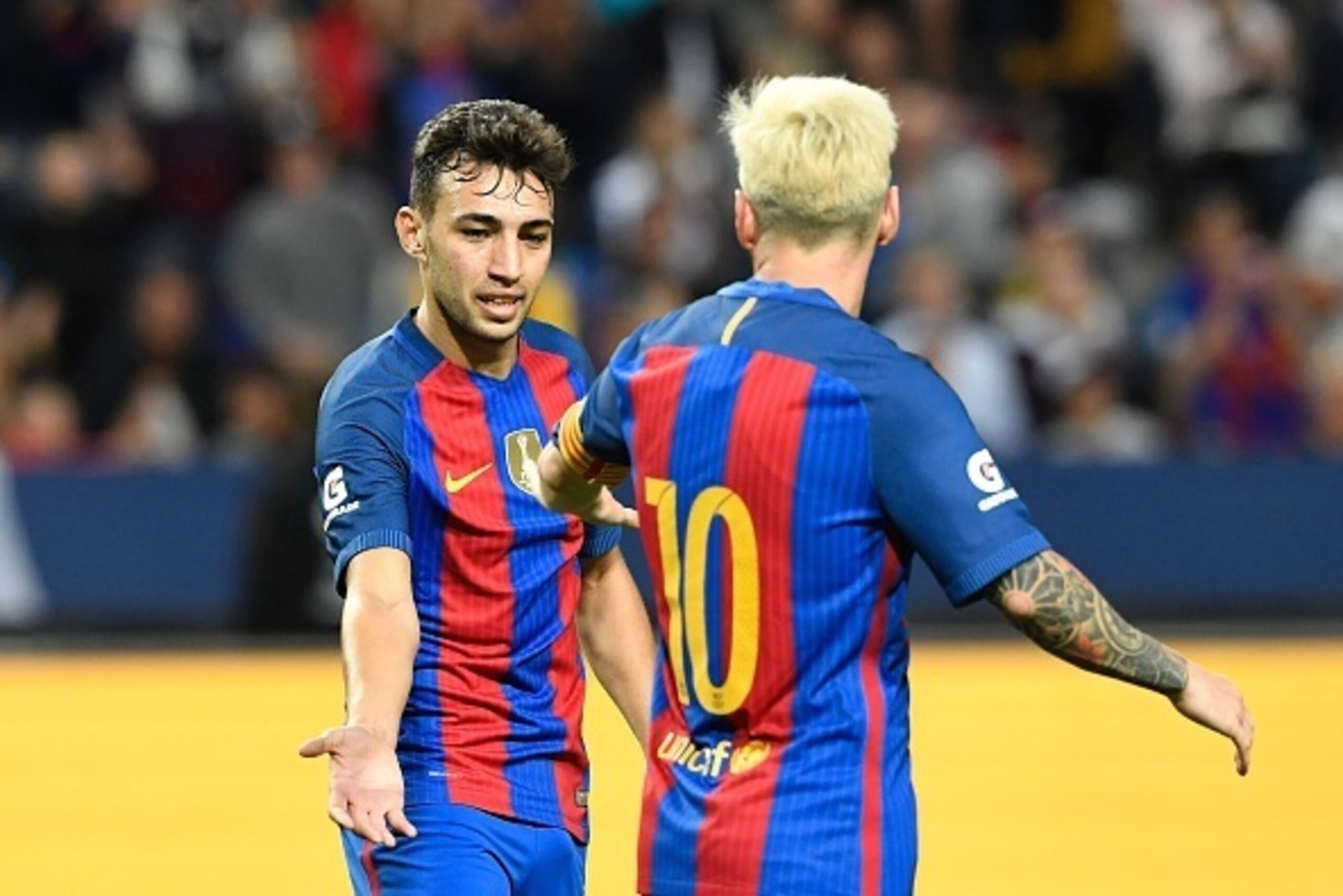 Barcelona's Spanish Forward Munir El Haddadi (L) celebrates with his teammate Argentinian forward Lionel Messi after scoring a goal during the 2016 International Champions Cup football match between FC Barcelona and Leicester City at Friends Arena on Augu