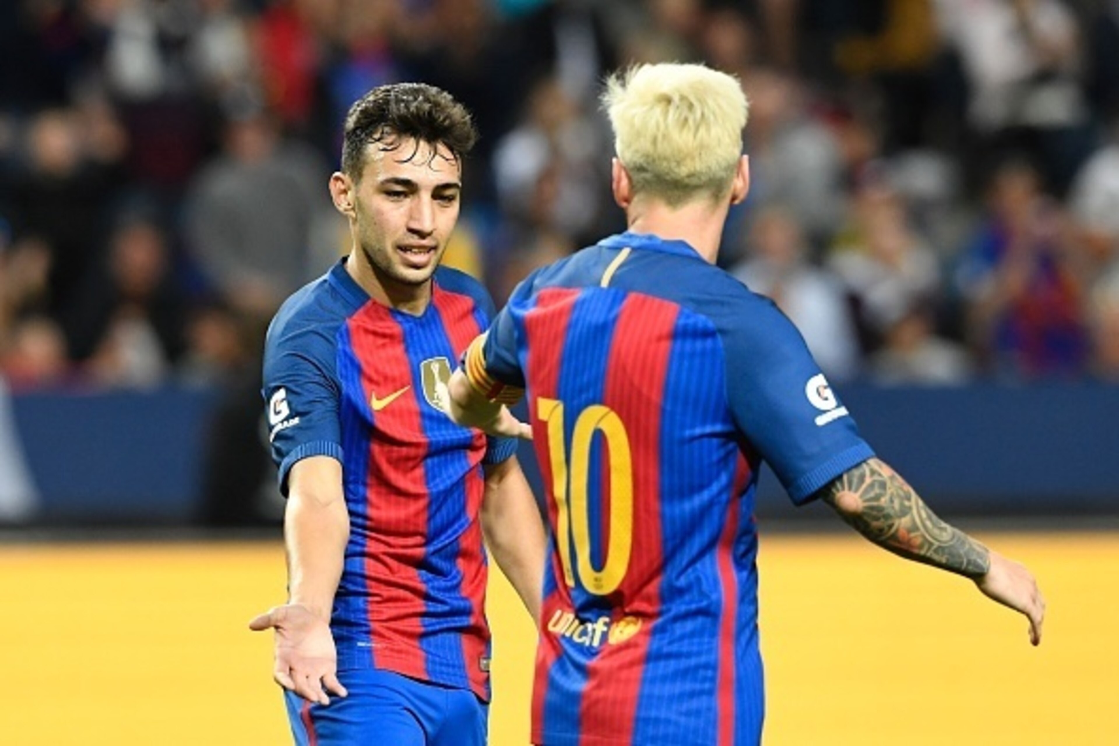 Barcelona's Spanish Forward Munir El Haddadi (L) celebrates with his teammate Argentinian forward Lionel Messi after scoring a goal during the 2016 International Champions Cup football match between FC Barcelona and Leicester City at Friends Arena on Augu Barcelona's Spanish Forward Munir El Haddadi (L) celebrates with his teammate Argentinian forward Lionel Messi after scoring a goal during the 2016 International Champions Cup football match between FC Barcelona and Leicester City at Friends Arena on Augu