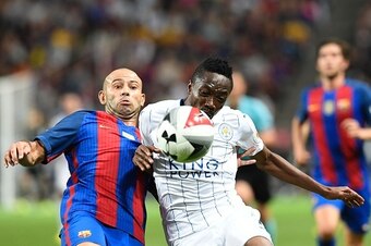 Leicester's Nigerian forward Ahmed Musa (R) vies with  Barcelona Argentinian defender Javier Mascherano during the 2016 International Champions Cup friendly football match between FC Barcelona and Leicester City at Friends Arena on August 3, 2016 in Solna