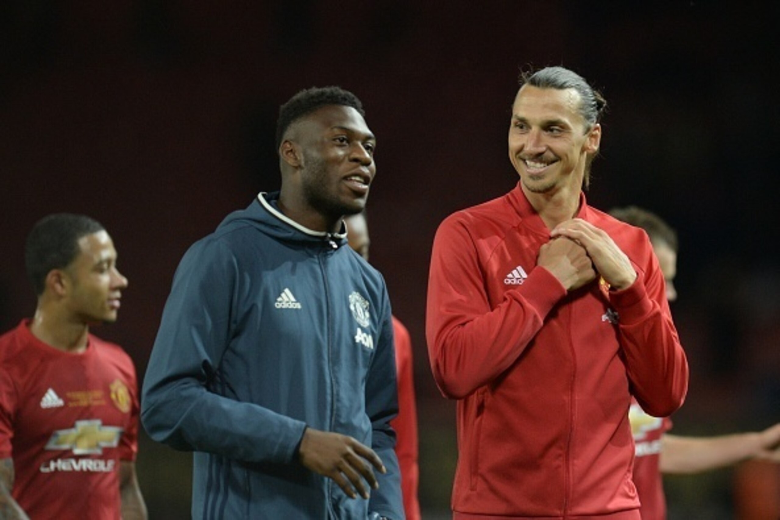 Manchester United's Swedish striker Zlatan Ibrahimovic (R) talks with Manchester United's Dutch defender Timothy Fosu-Mensah (L) at the end of the friendly Wayne Rooney testimonial football match between Manchester United and Everton at Old Trafford in Ma